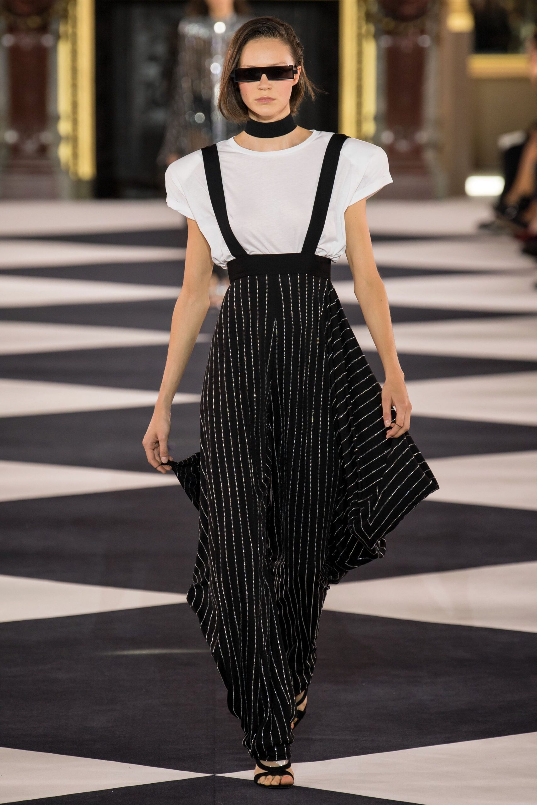 white relaxed top with black striped pants