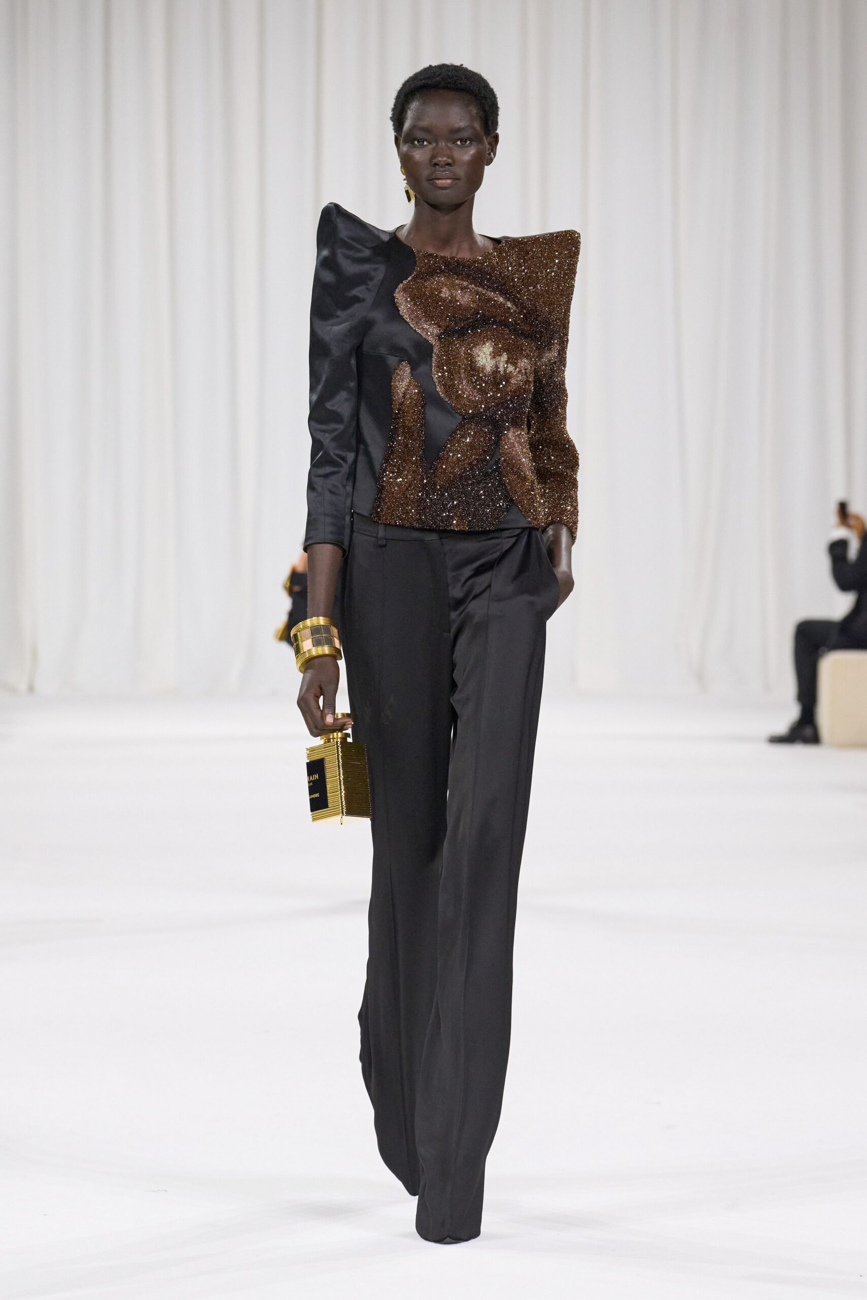 black embellished top with gold bag