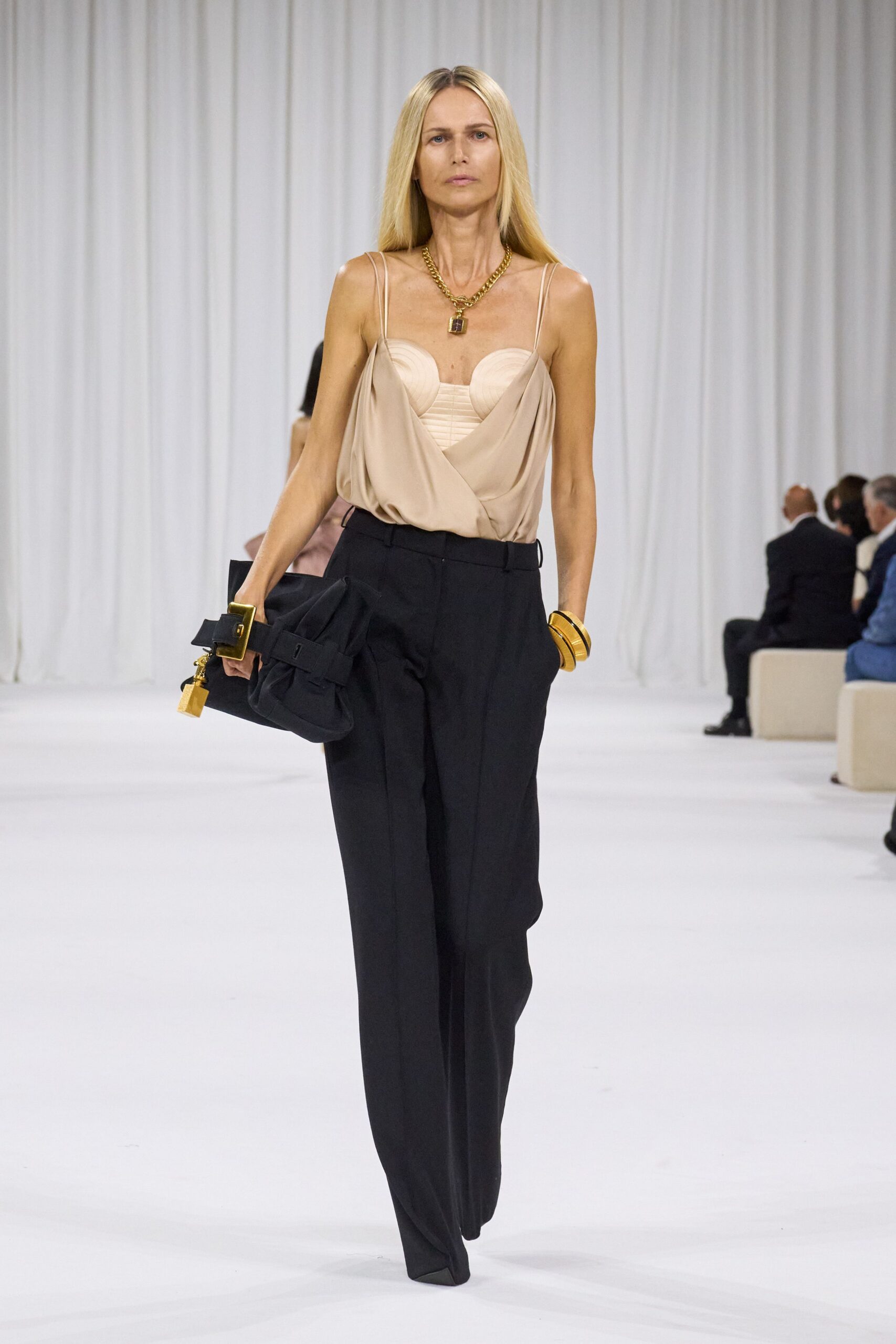 beige silk fitted top with black tailored pants
