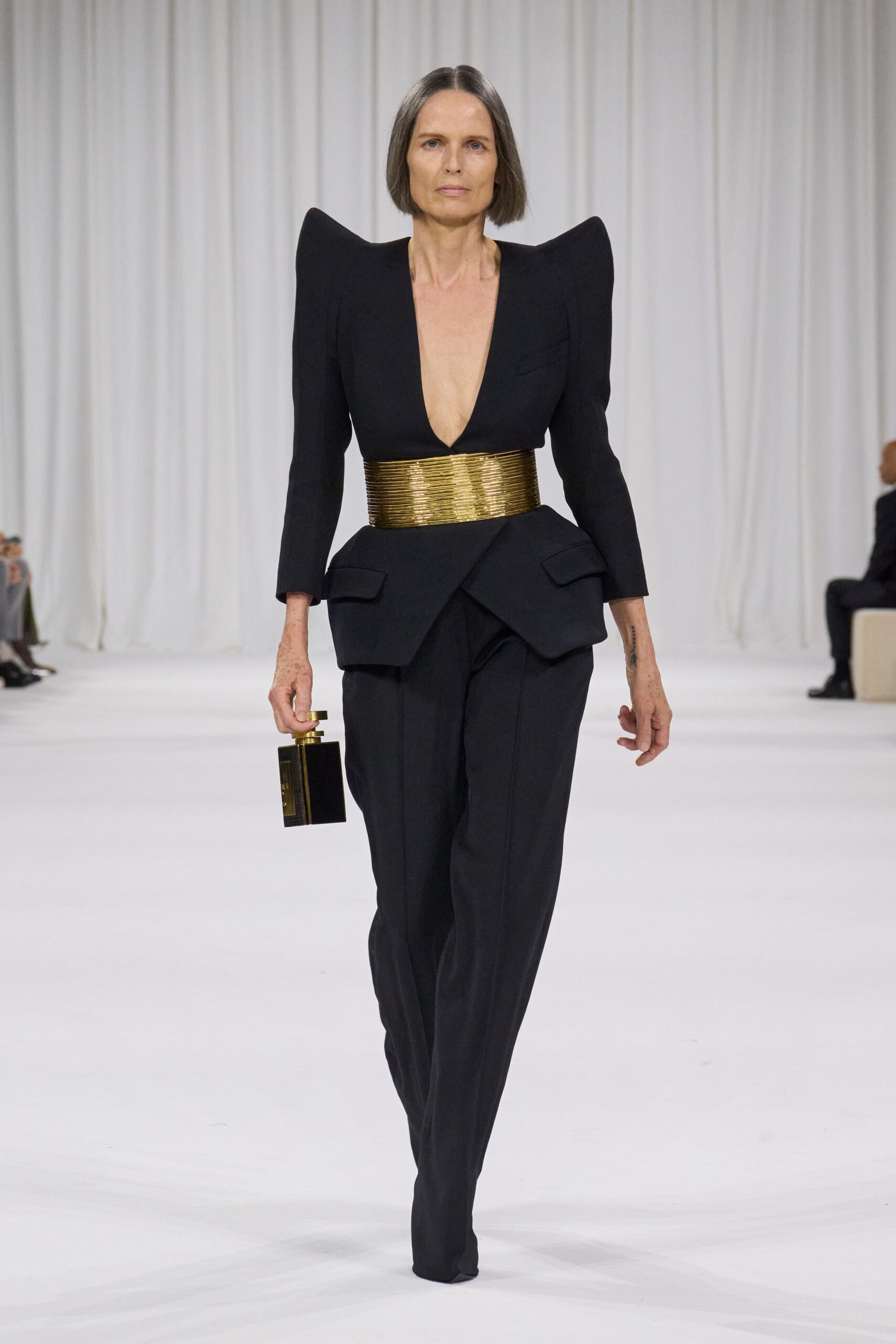 black tailored suit with gold belt