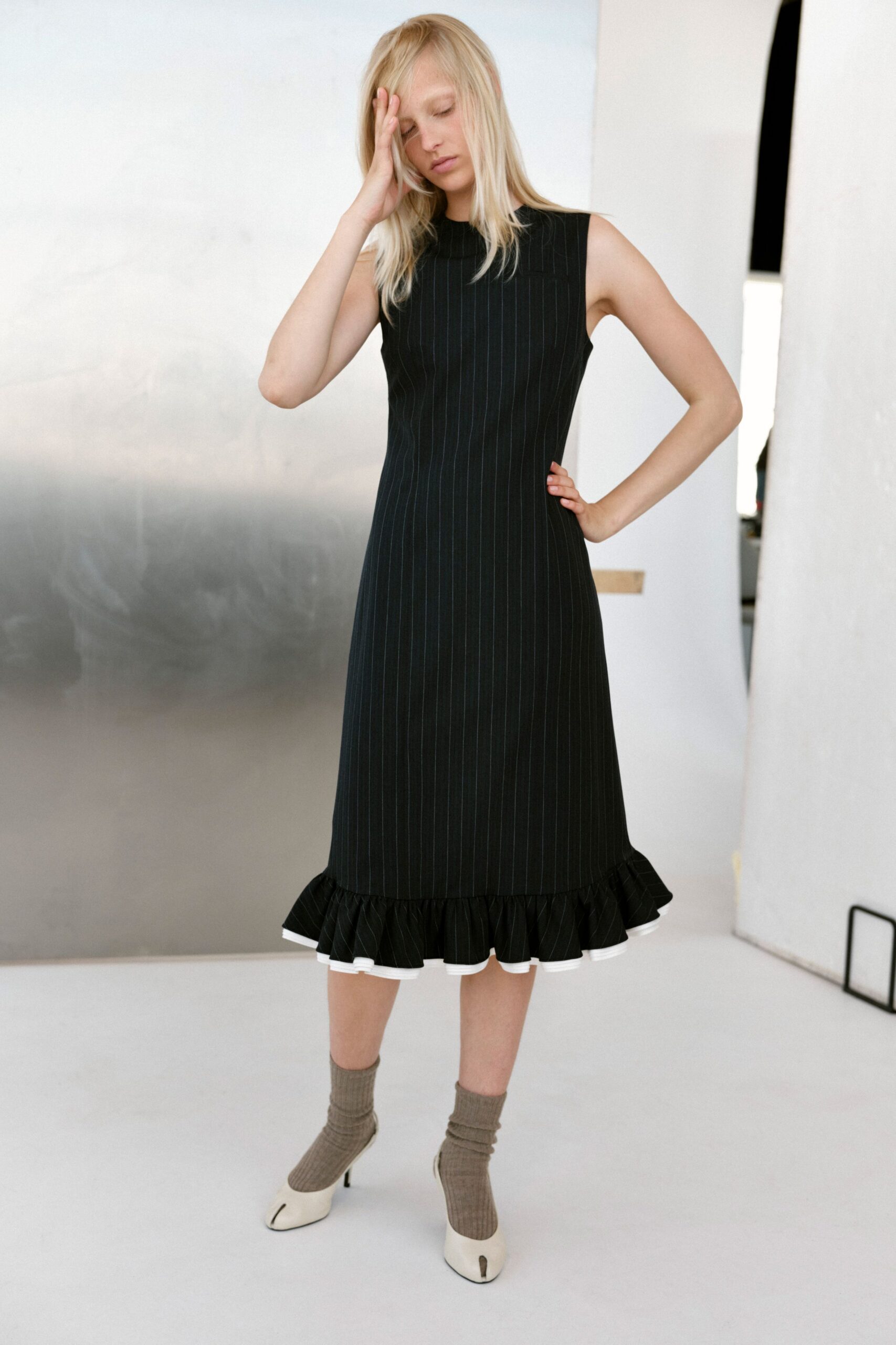 black cotton sleeveless high-neck fitted pleated ruffled dress