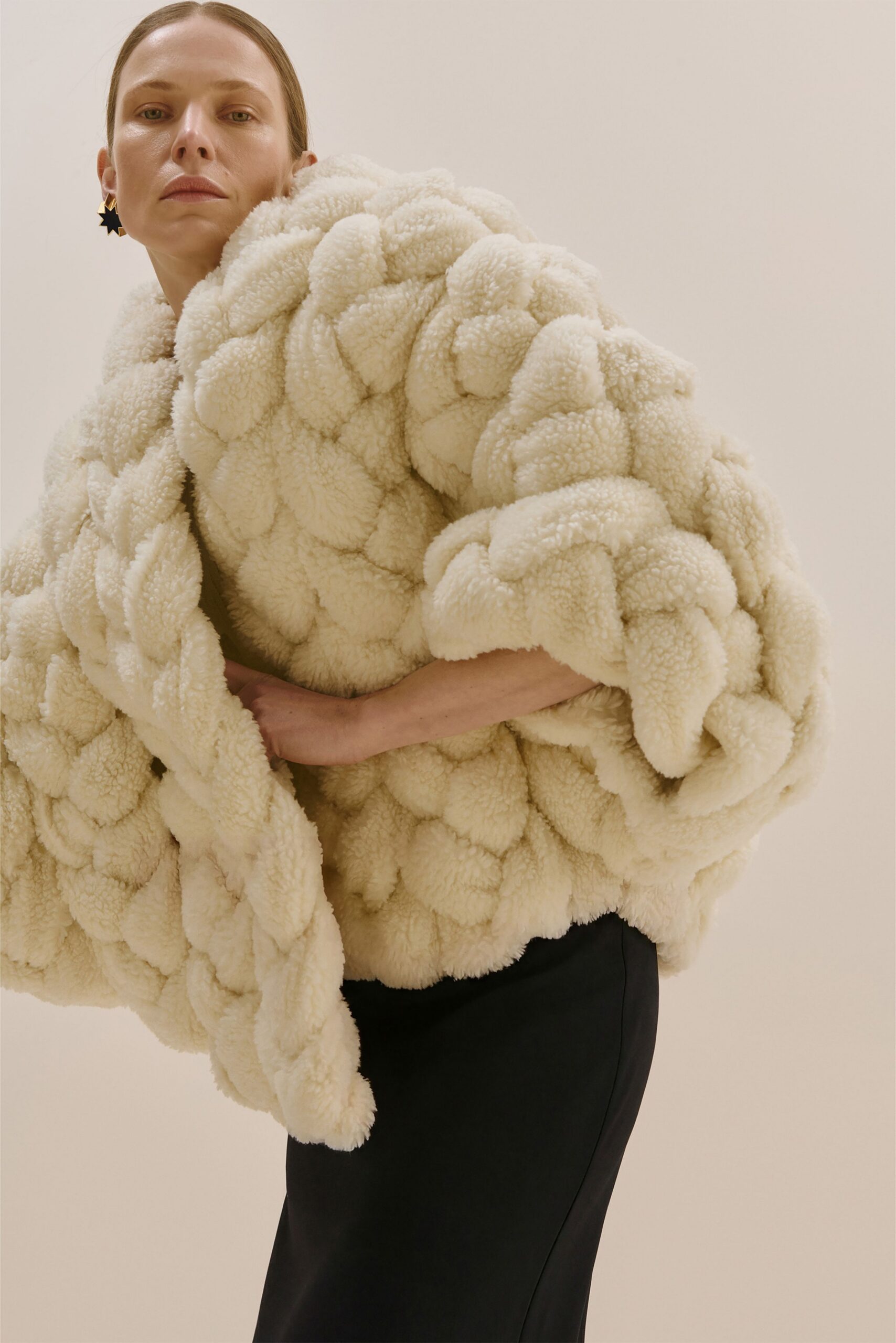 white faux-fur coat and black silk skirt