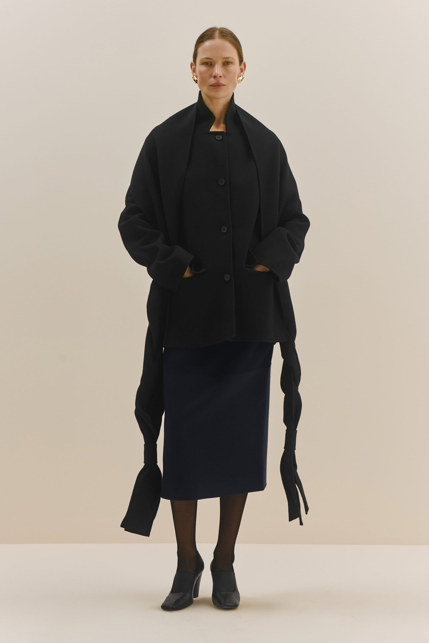 black wool coat with navy pencil skirt