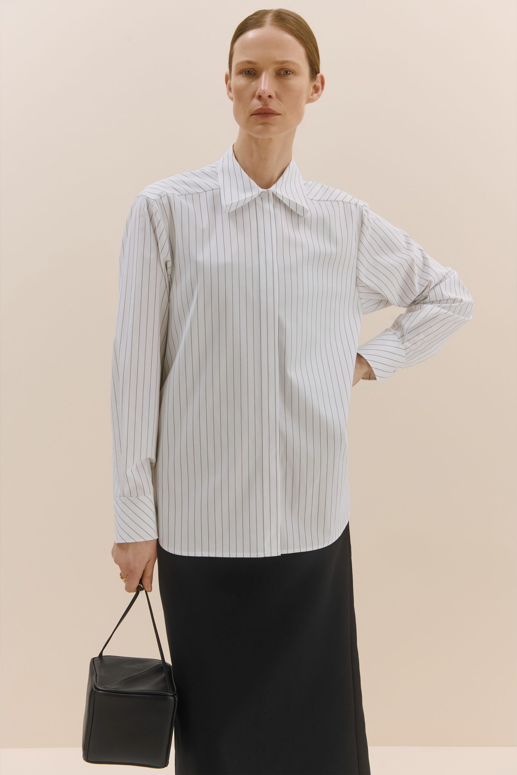 fitted striped shirt and black midi skirt