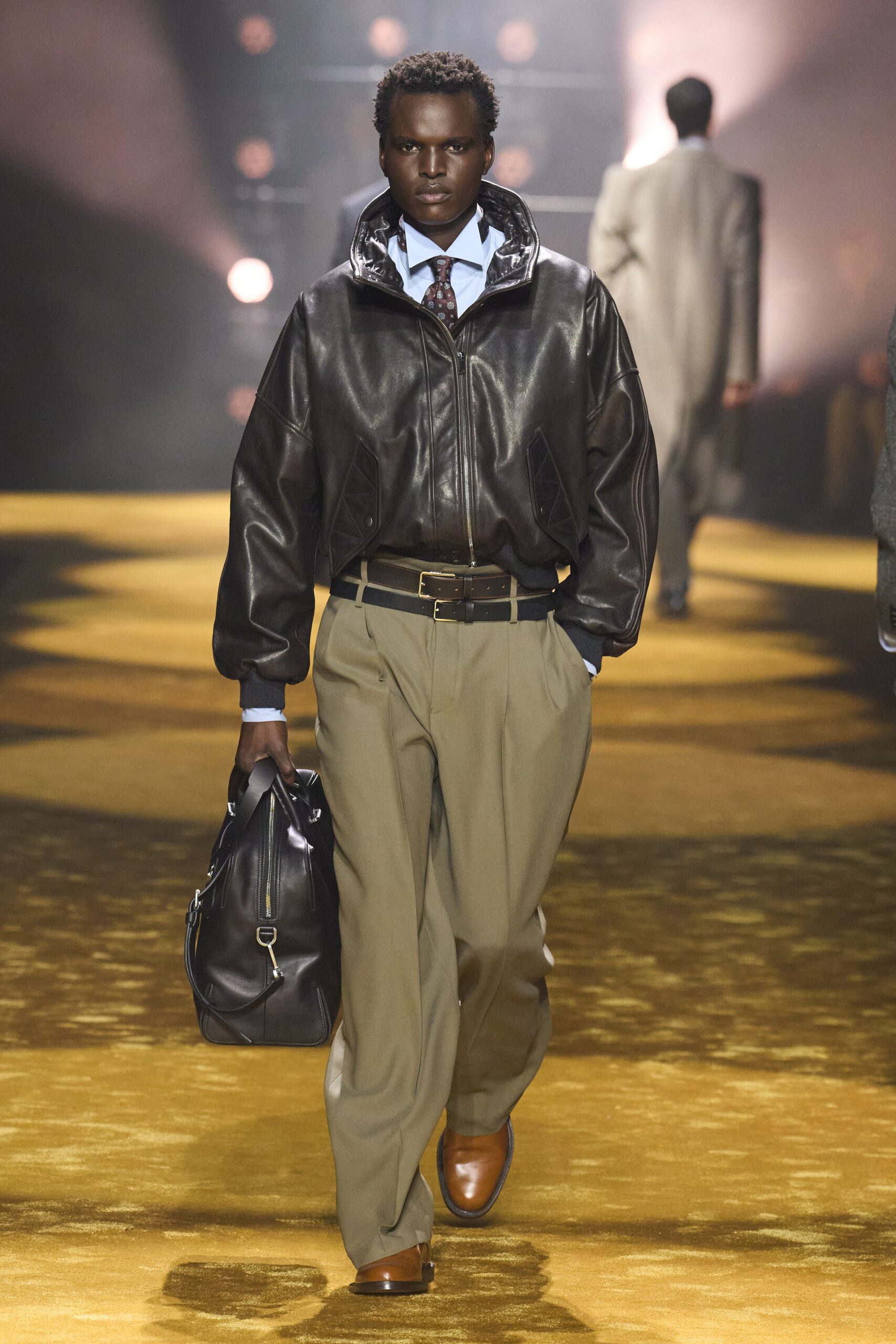 brown leather jacket with beige pants
