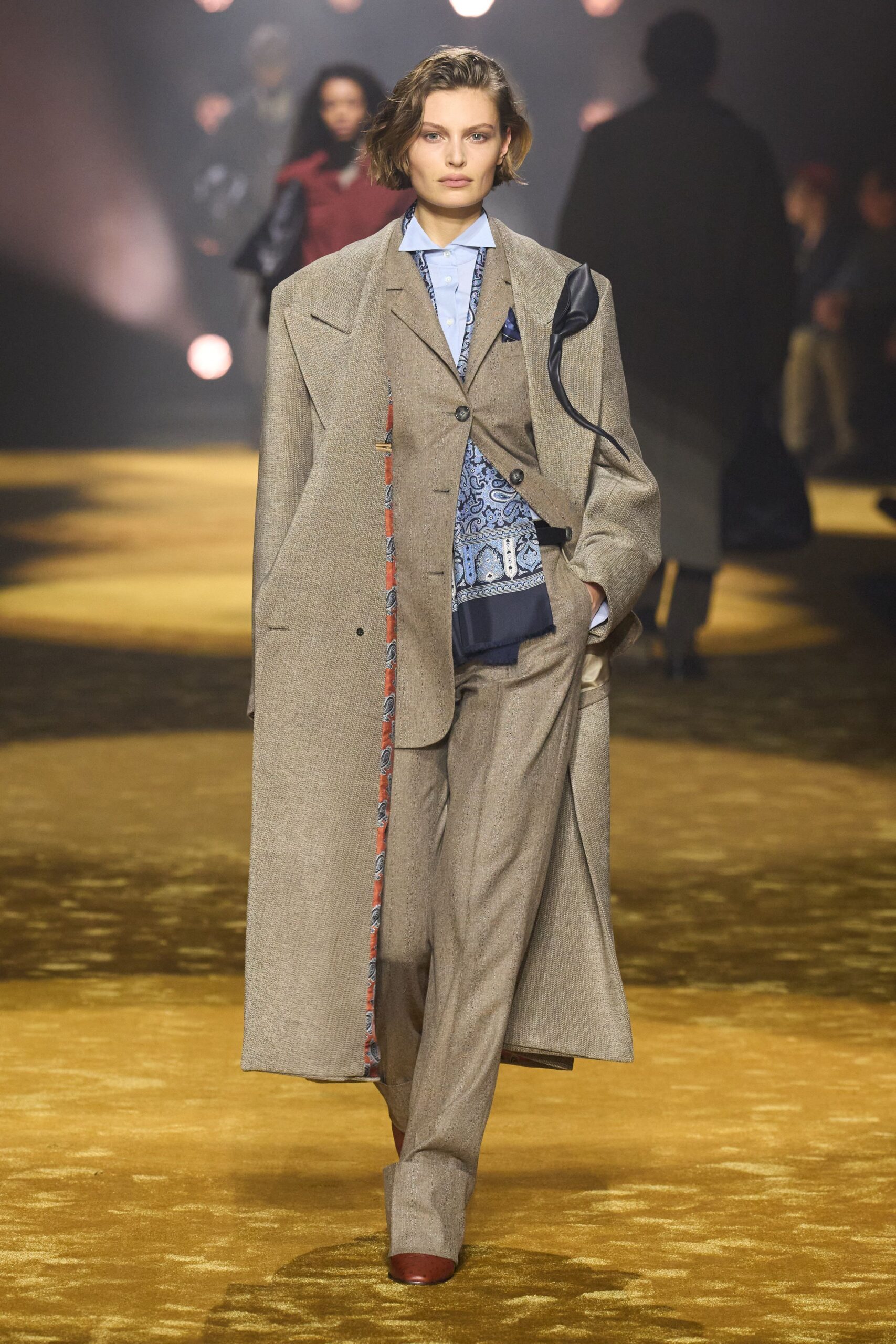 beige tailored suit with blue shirt