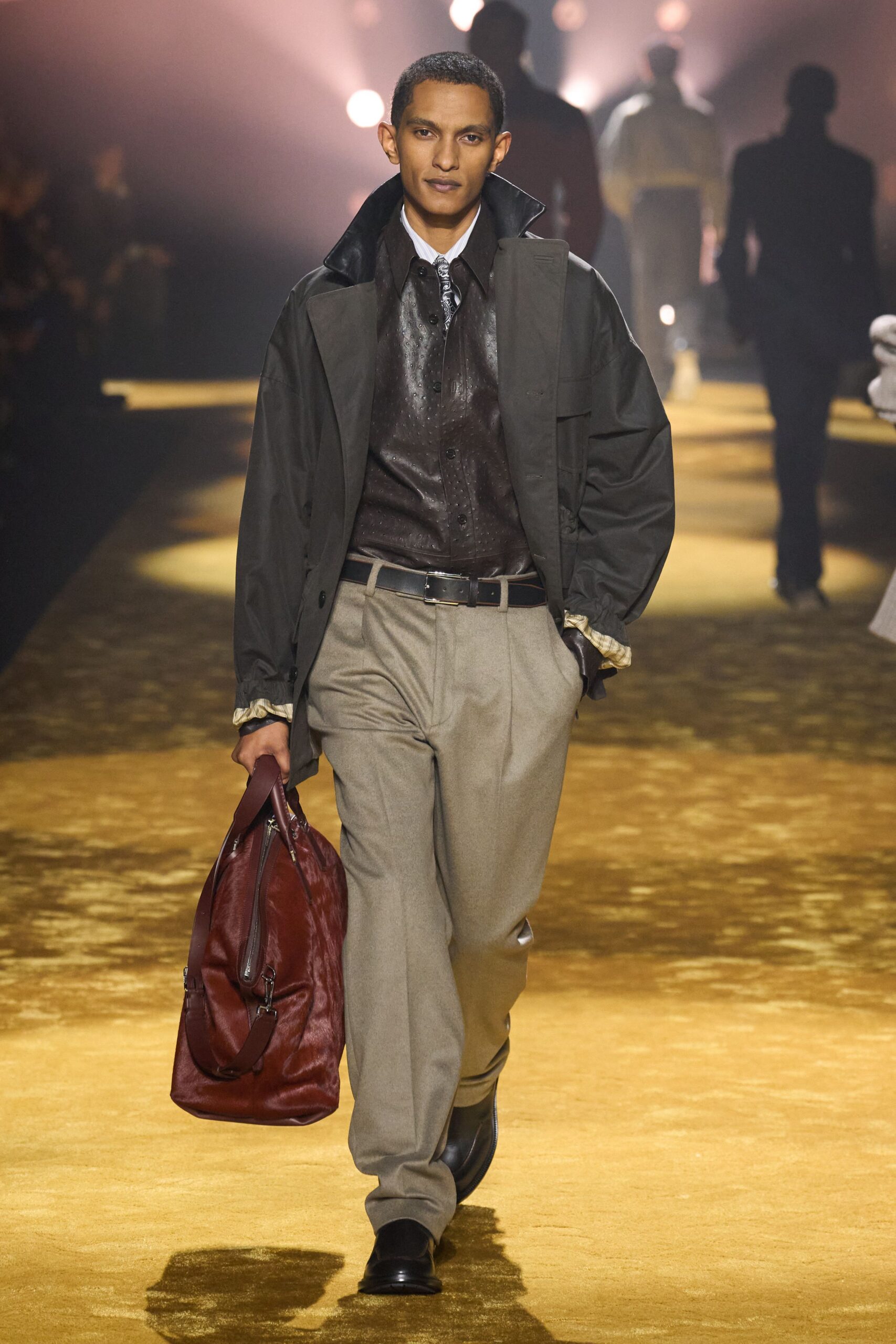 black jacket brown shirt beige pants