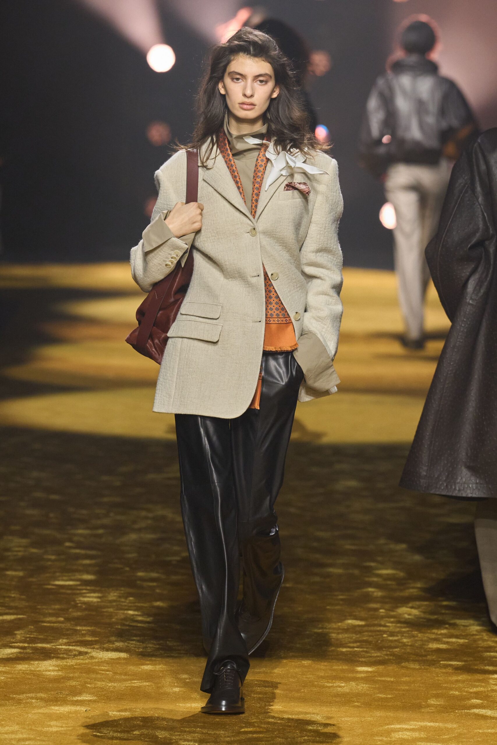 beige structured blazer with black leather pants