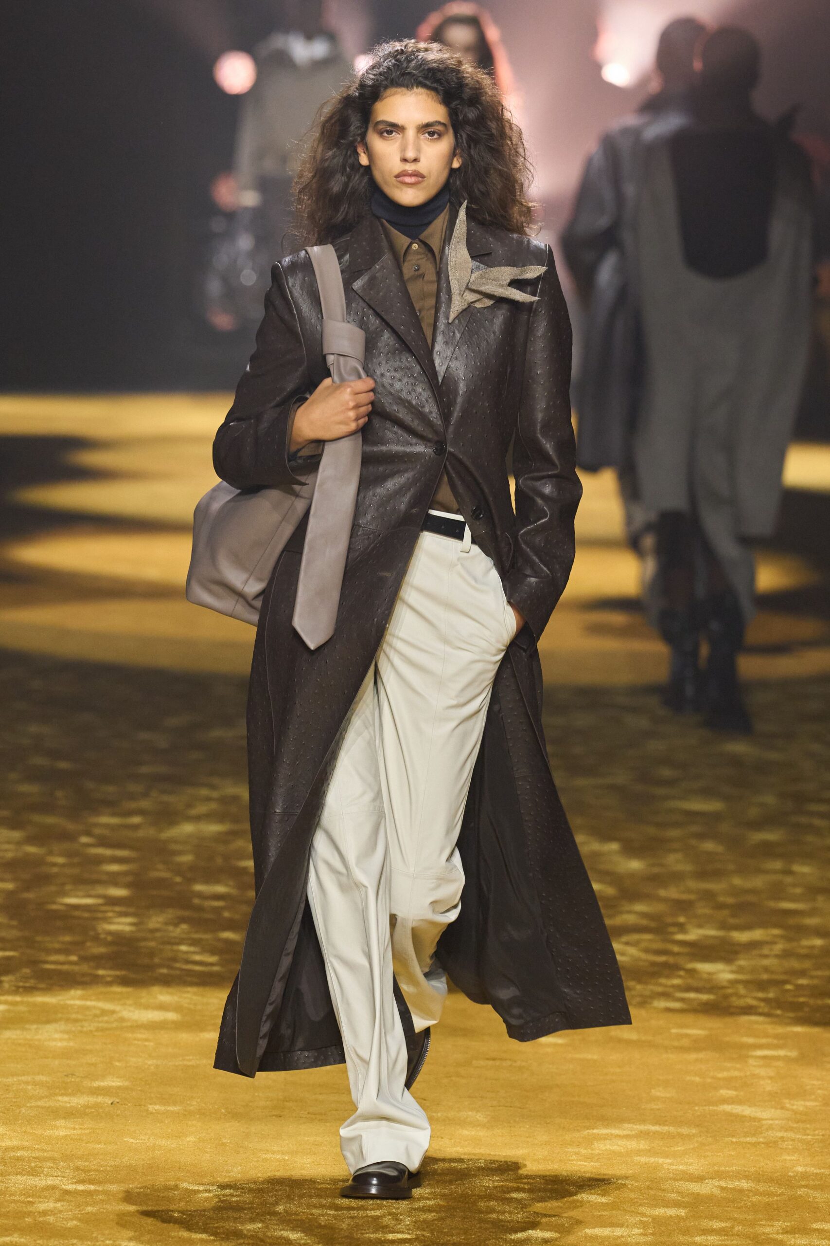 brown leather coat with white pants