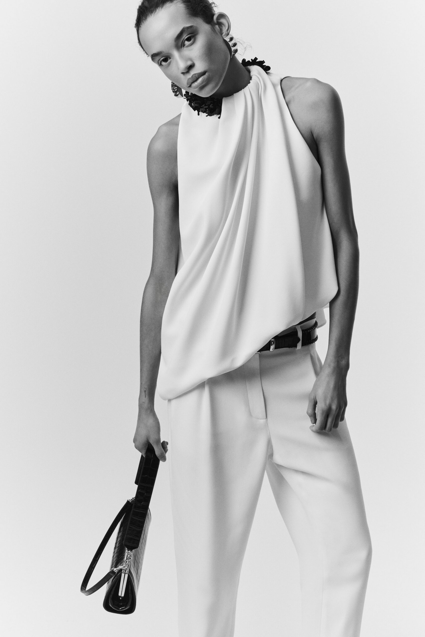 white silk sleeveless high-neck fitted draped top