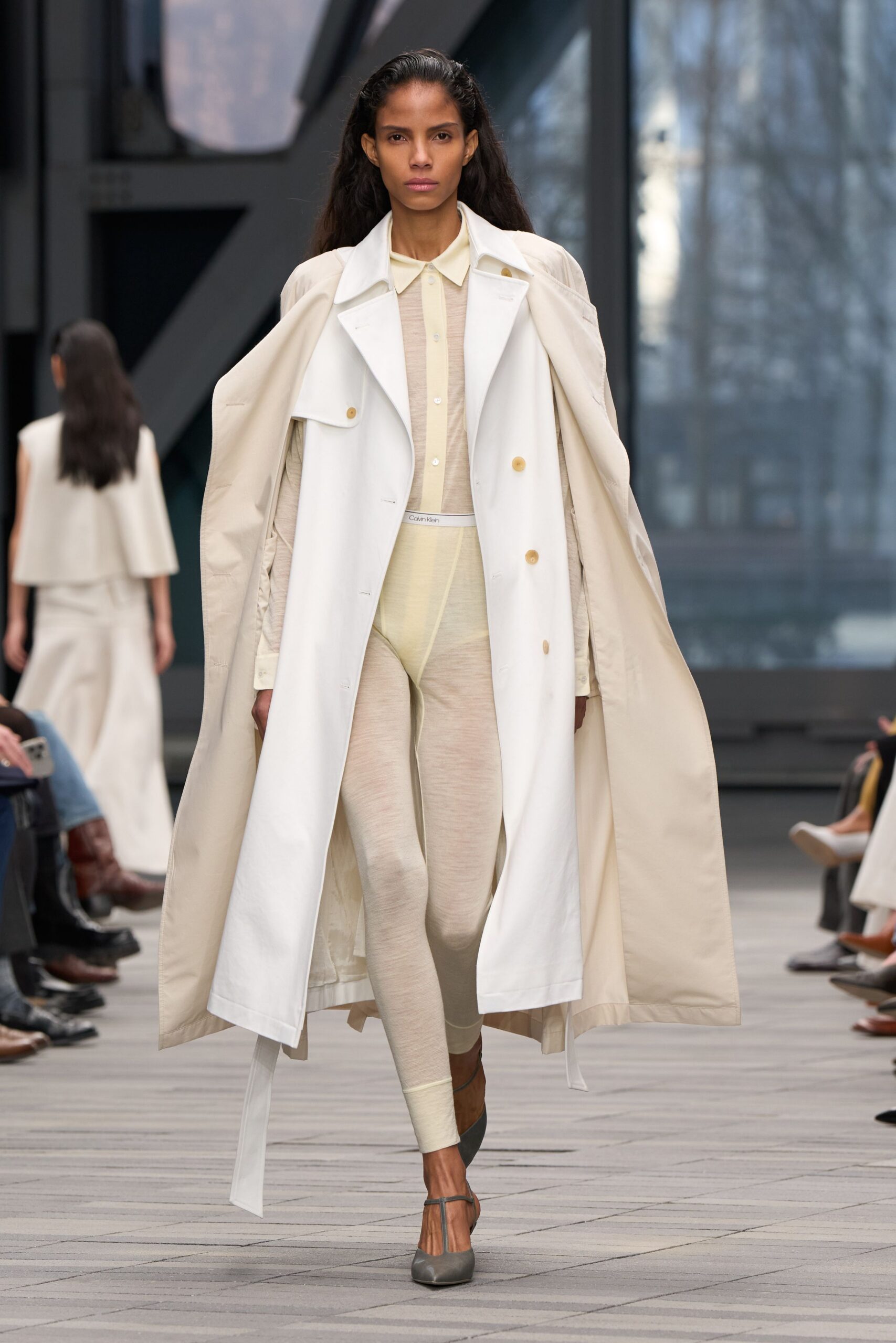 white coat beige shirt beige pants gray shoes