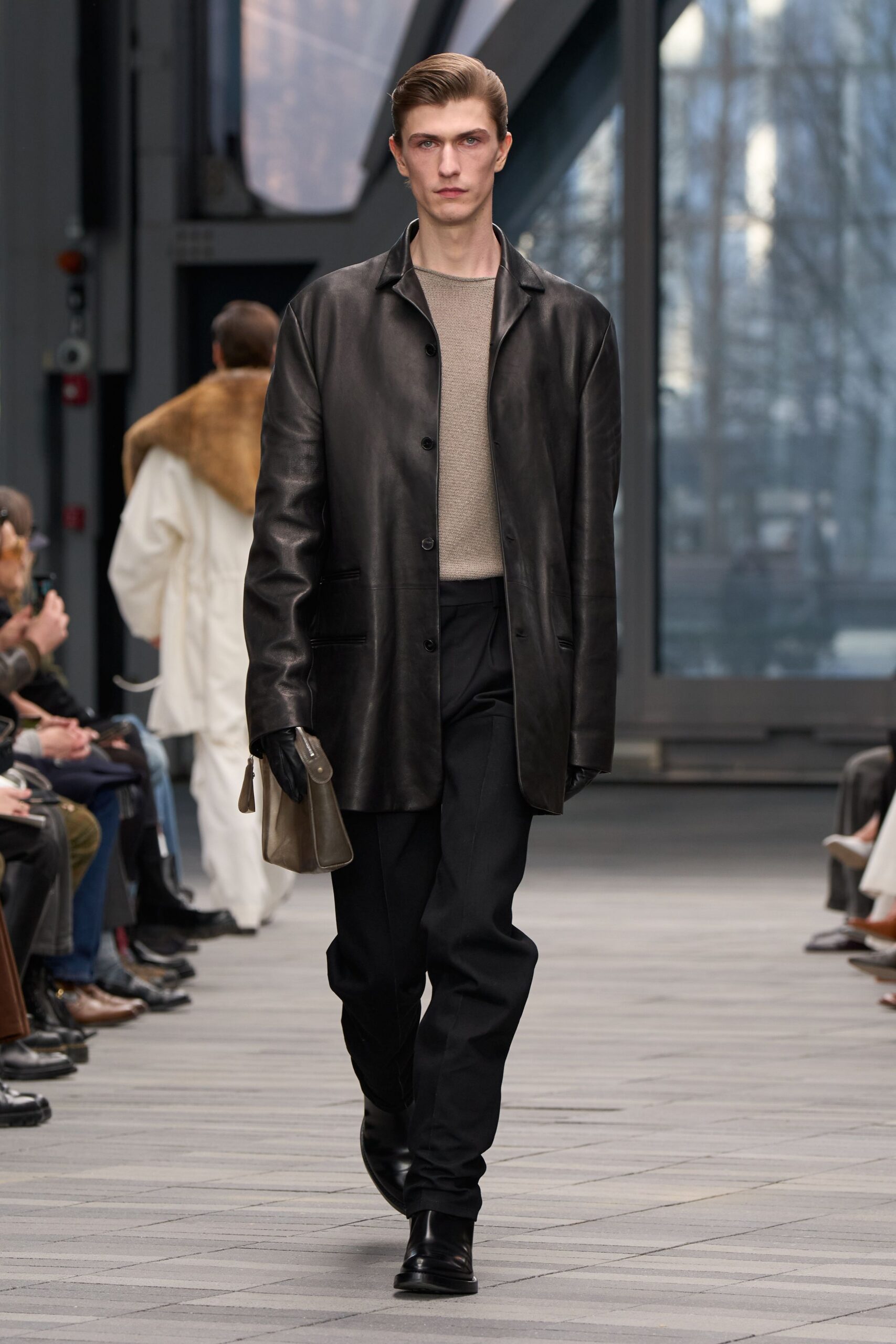 black leather jacket with beige sweater