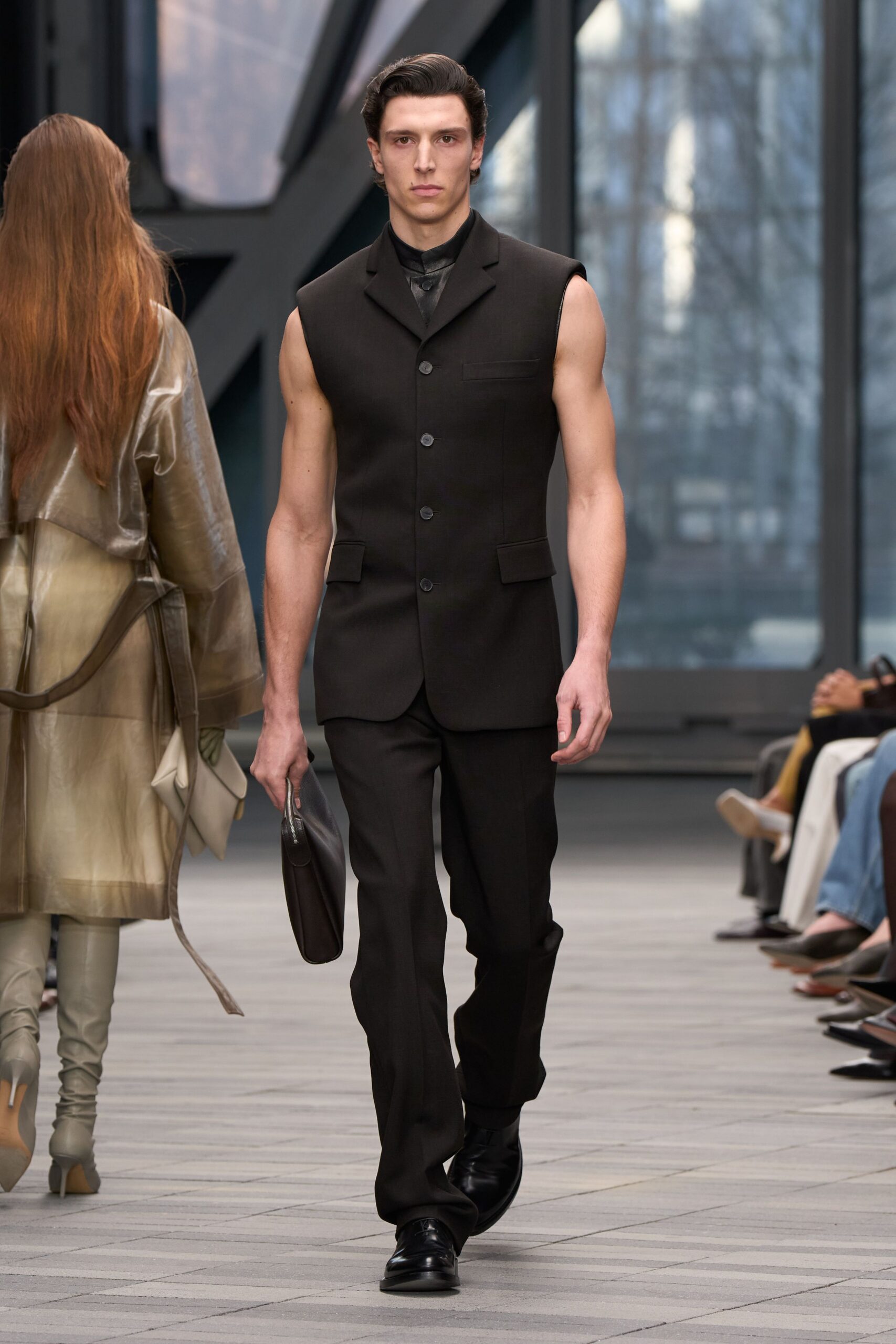 black fitted suit with leather bag