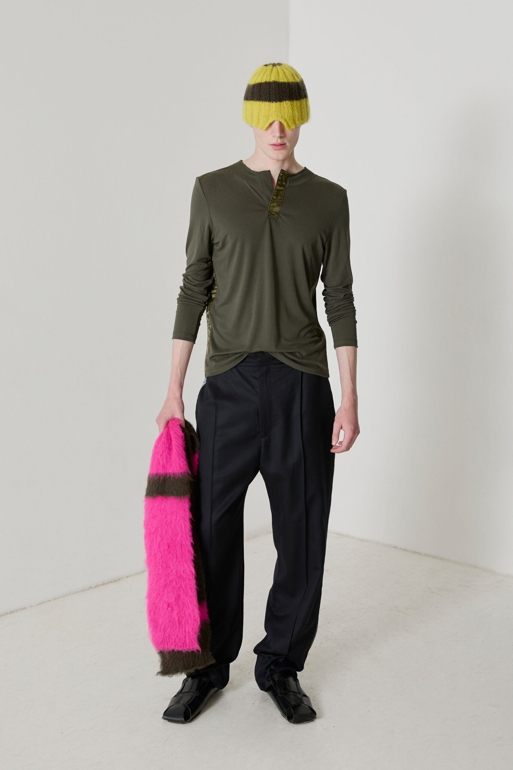 green relaxed top with black pants