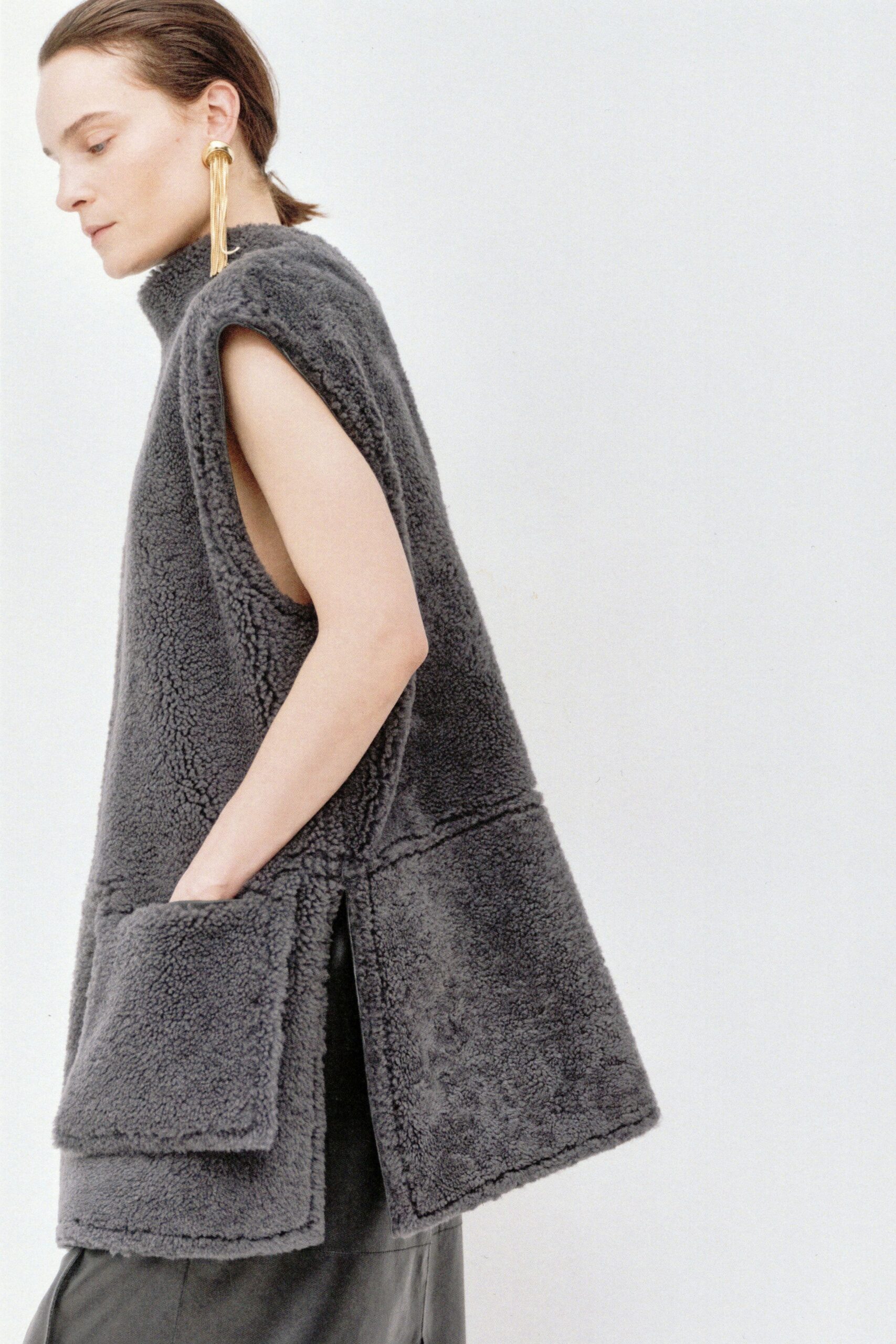 gray faux-fur vest and black leather skirt