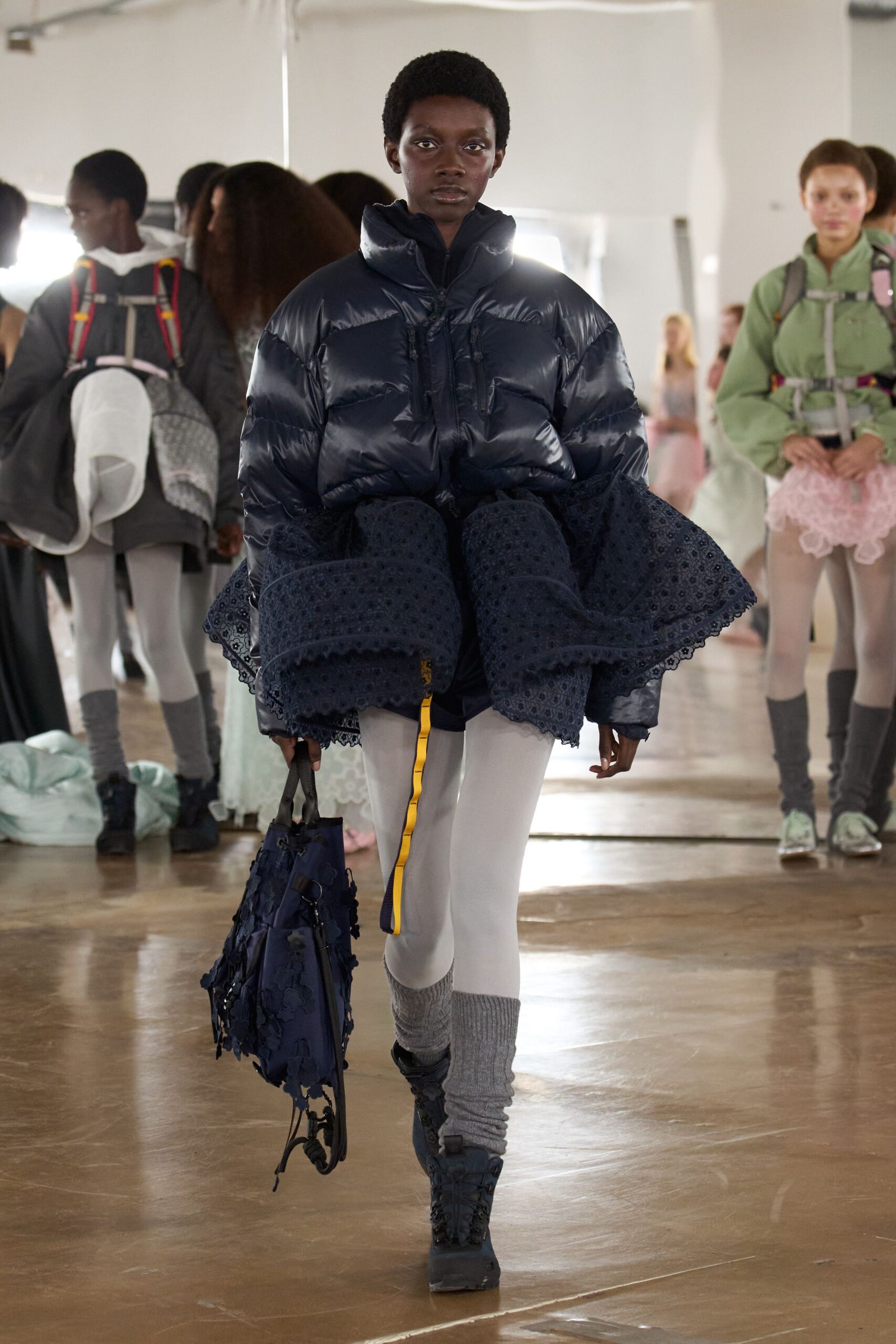 navy oversized puffer jacket with lace skirt