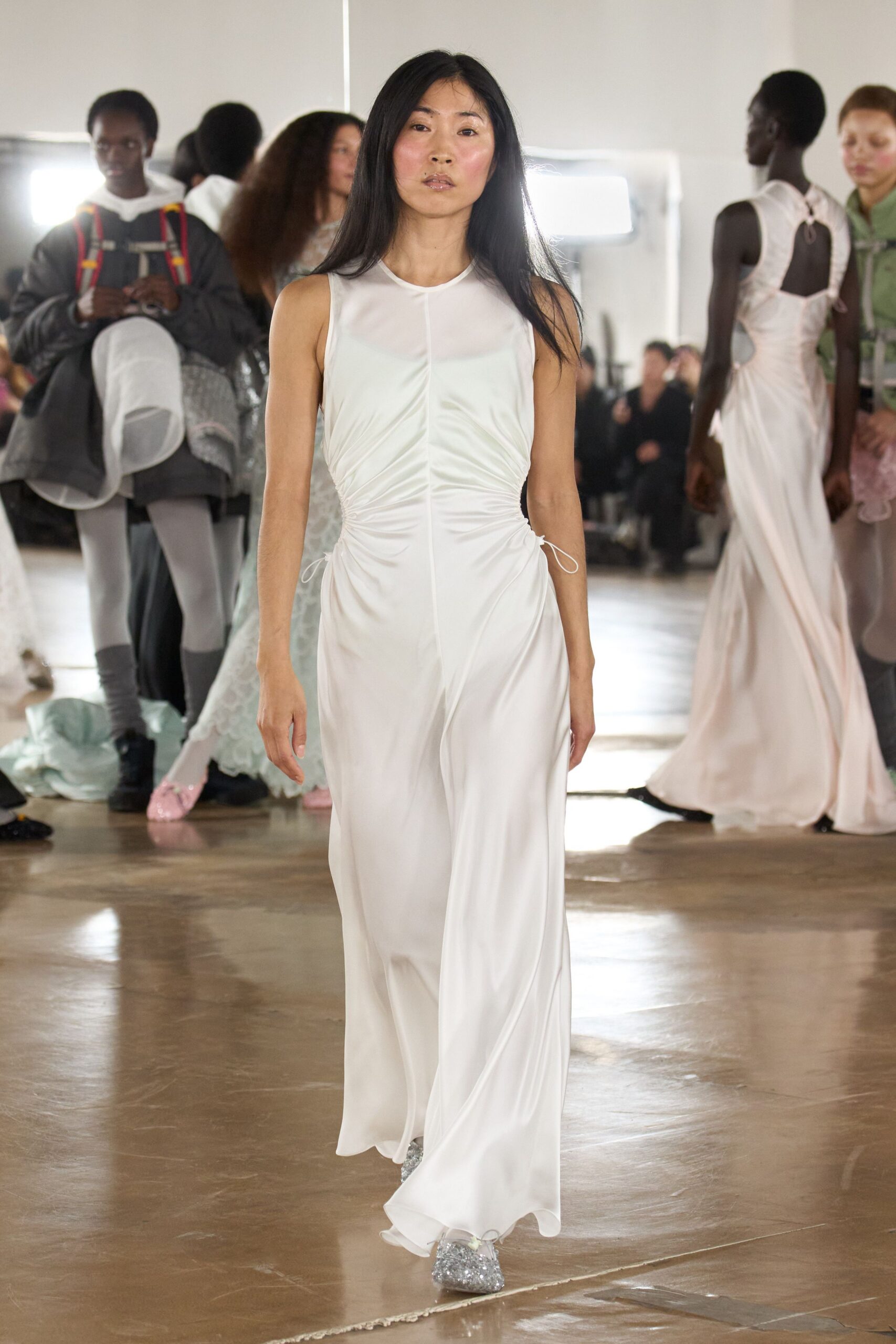 white silk fitted gown with silver shoes