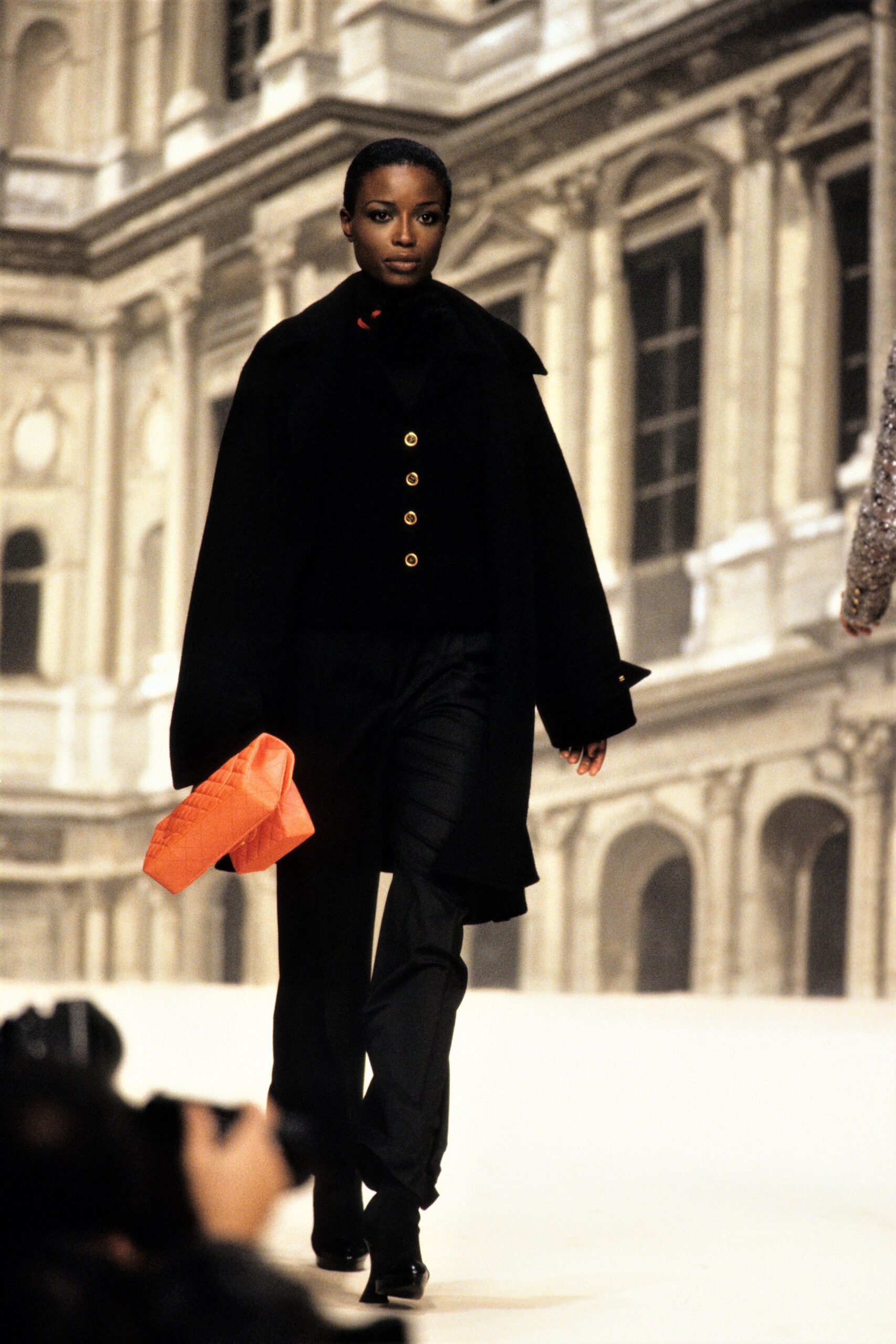 black wool coat with orange bag