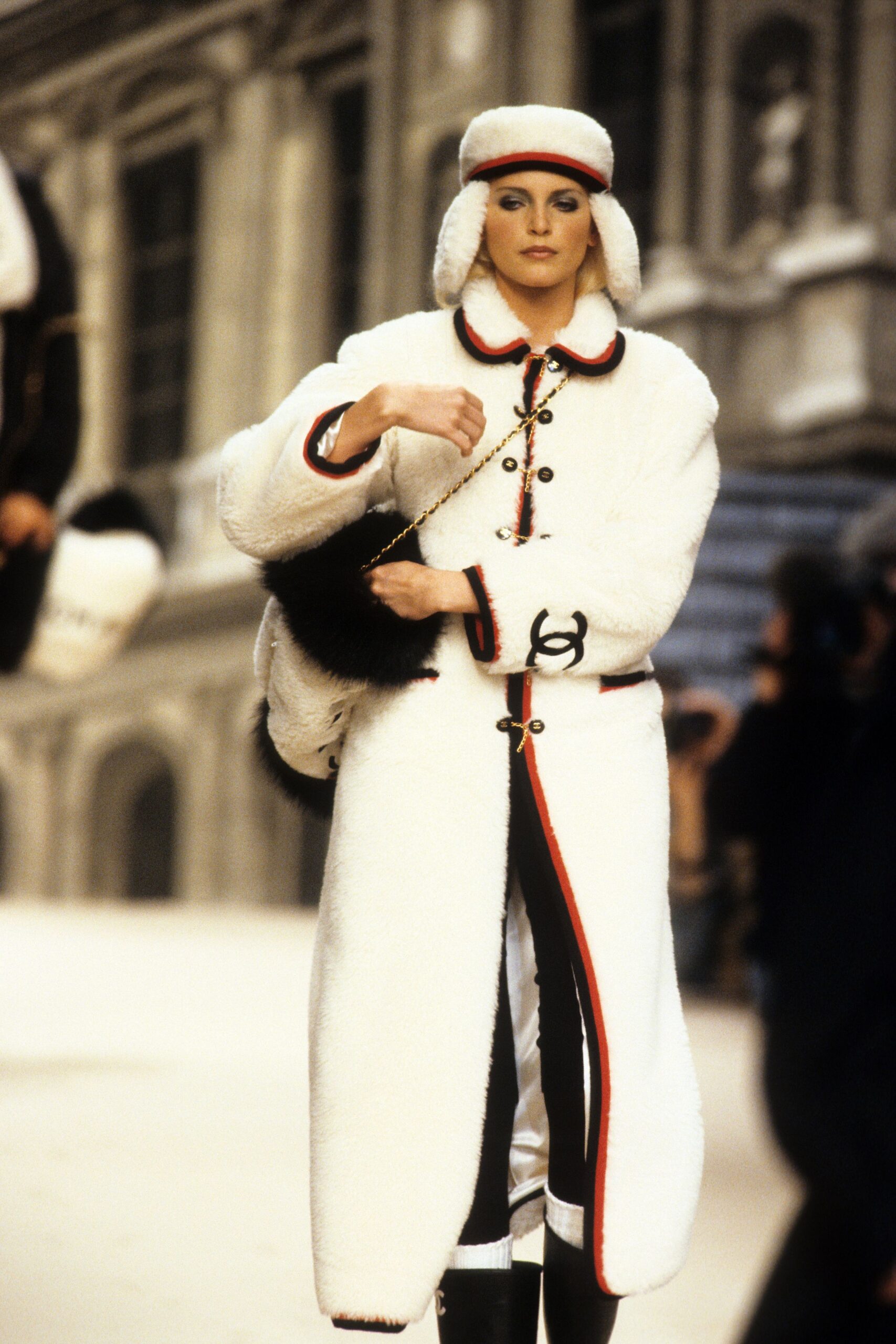 white faux-fur coat with black pants