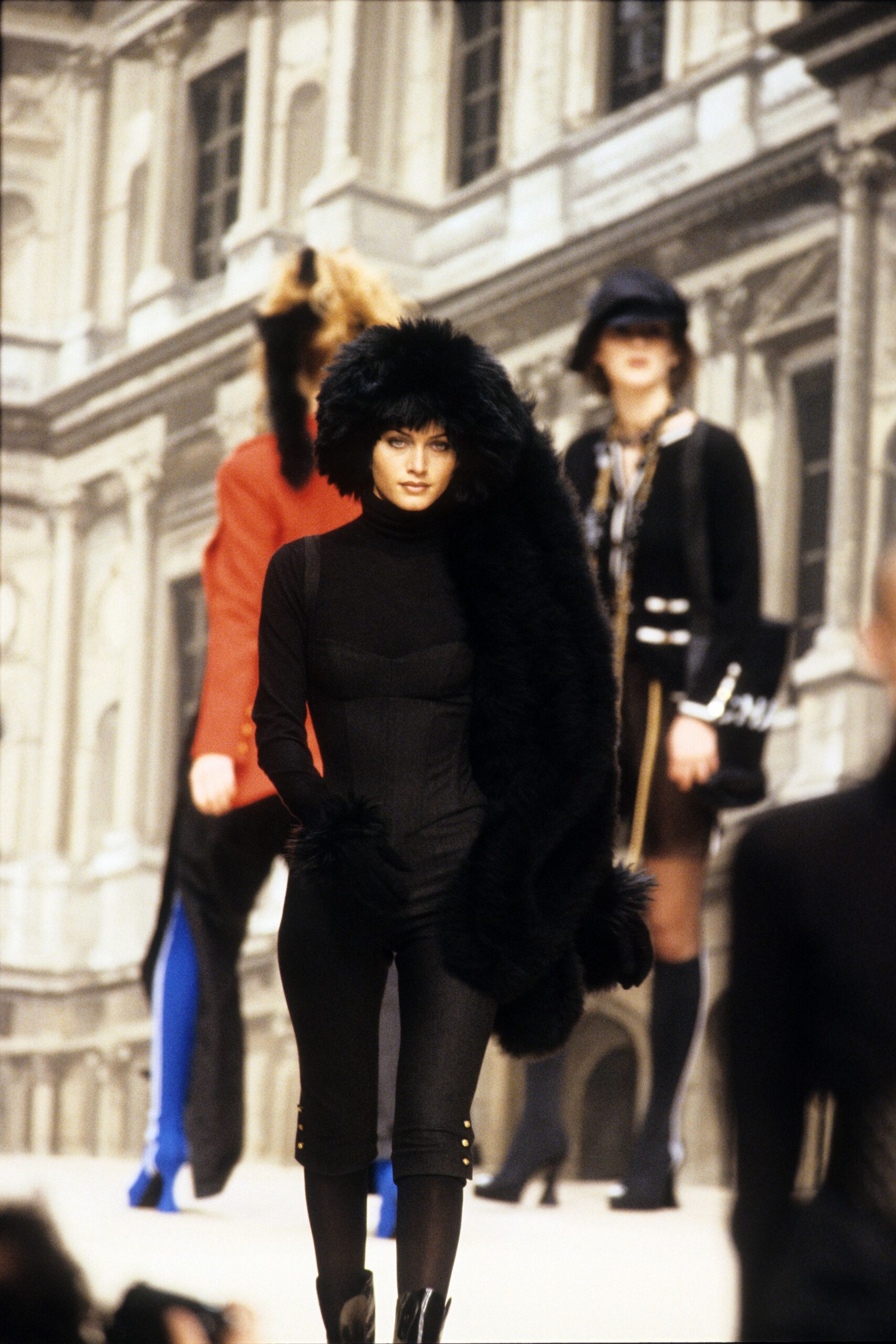 black fitted catsuit with faux-fur coat