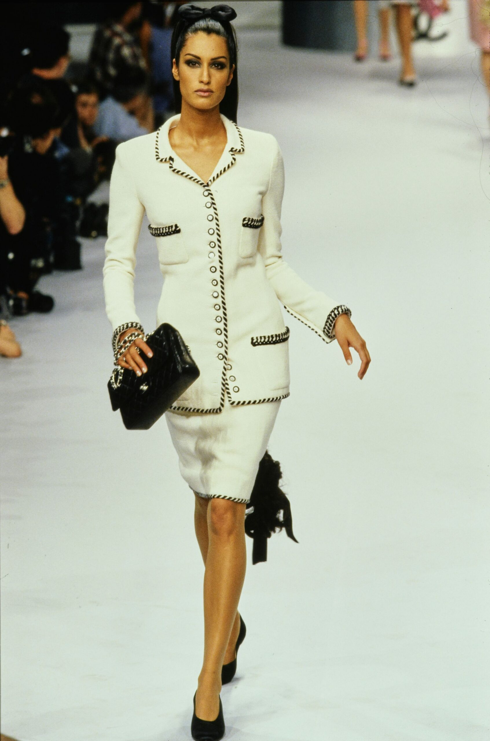 white fitted suit with black accessories