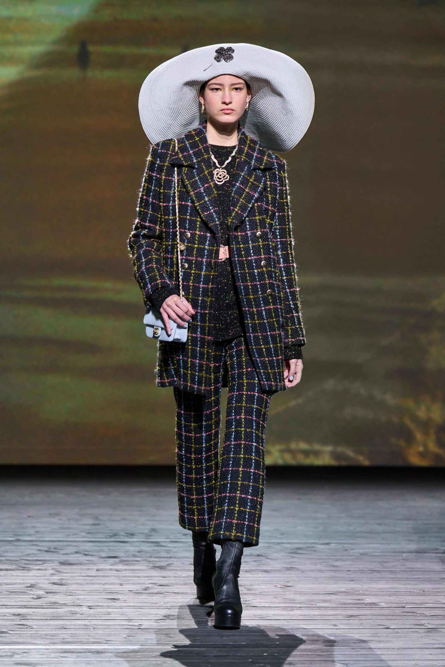 tailored black checked suit with wide-brimmed hat