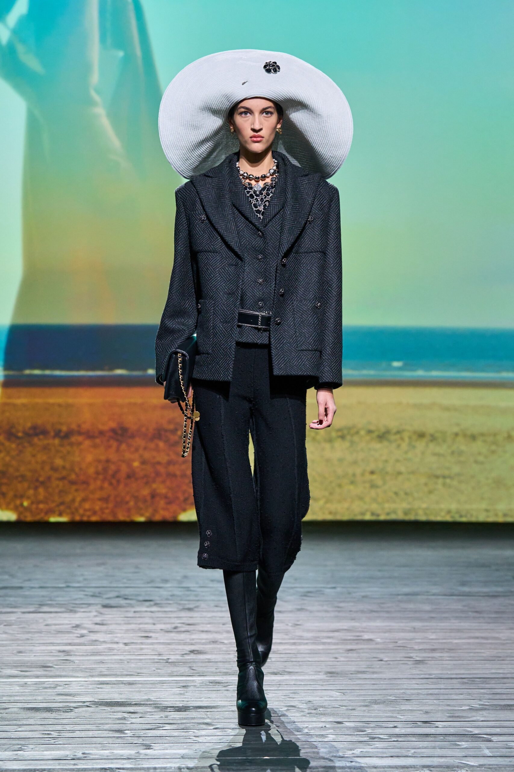 black tailored suit with white hat