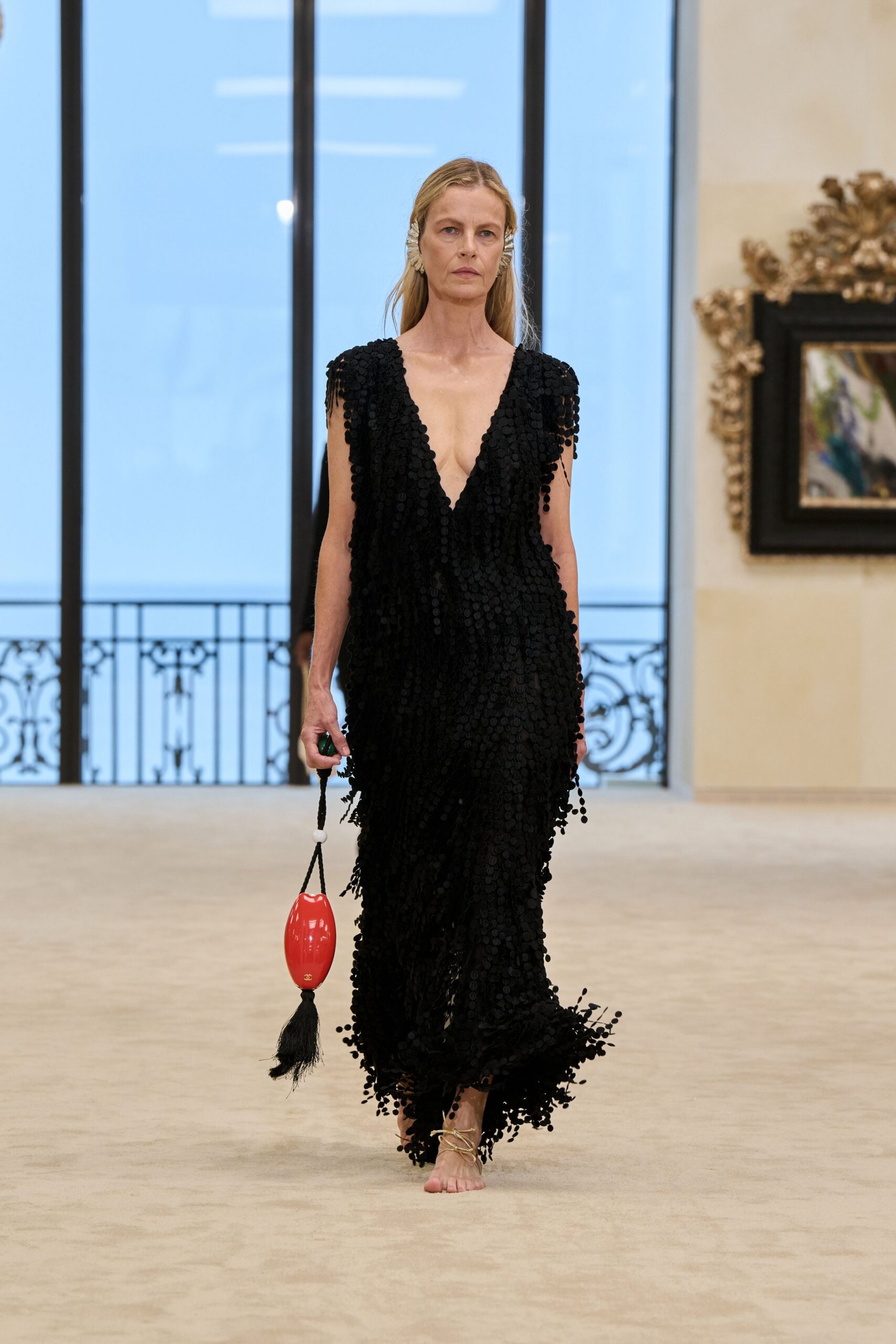 black fringed gown with red bag