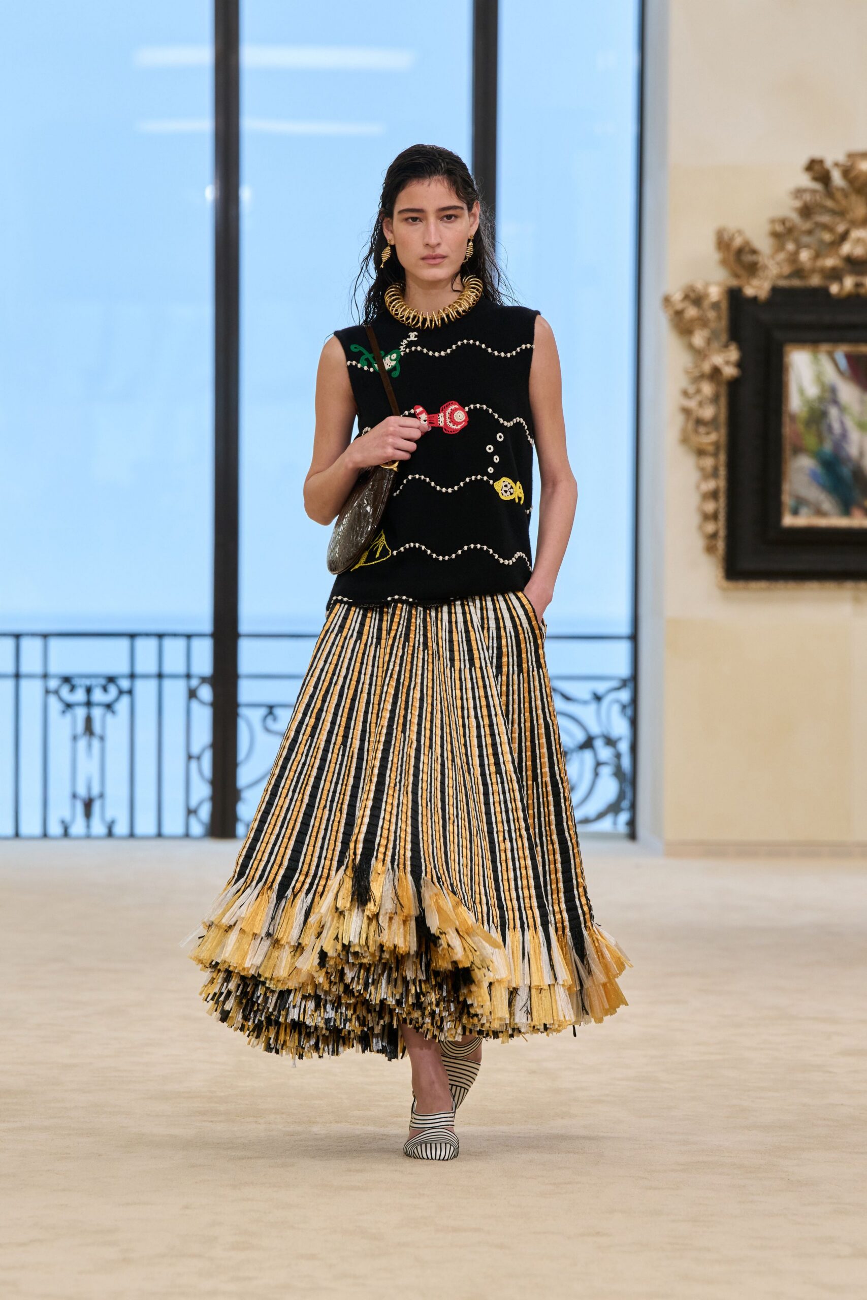 black embroidered top with pleated skirt