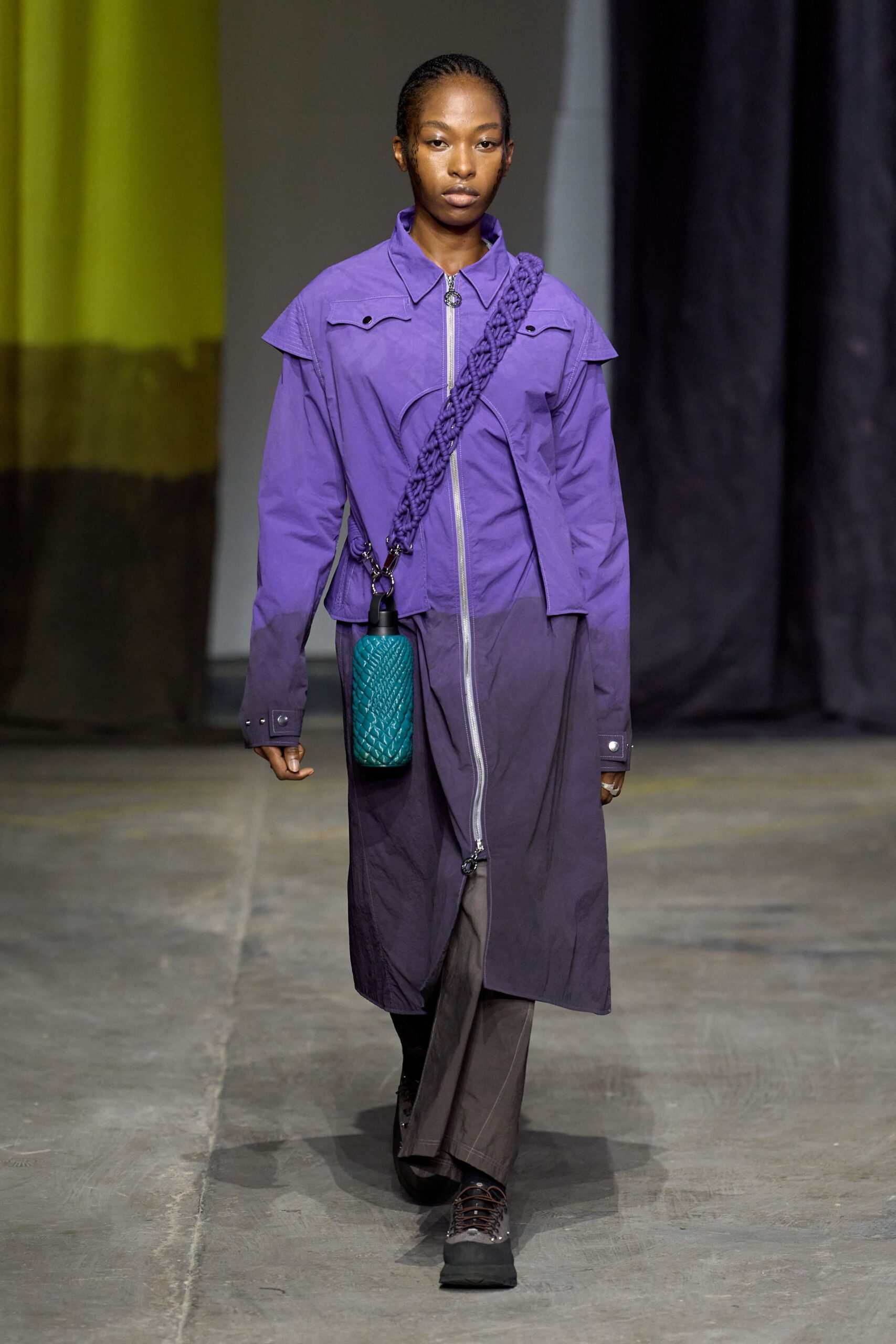 purple coat with teal bag