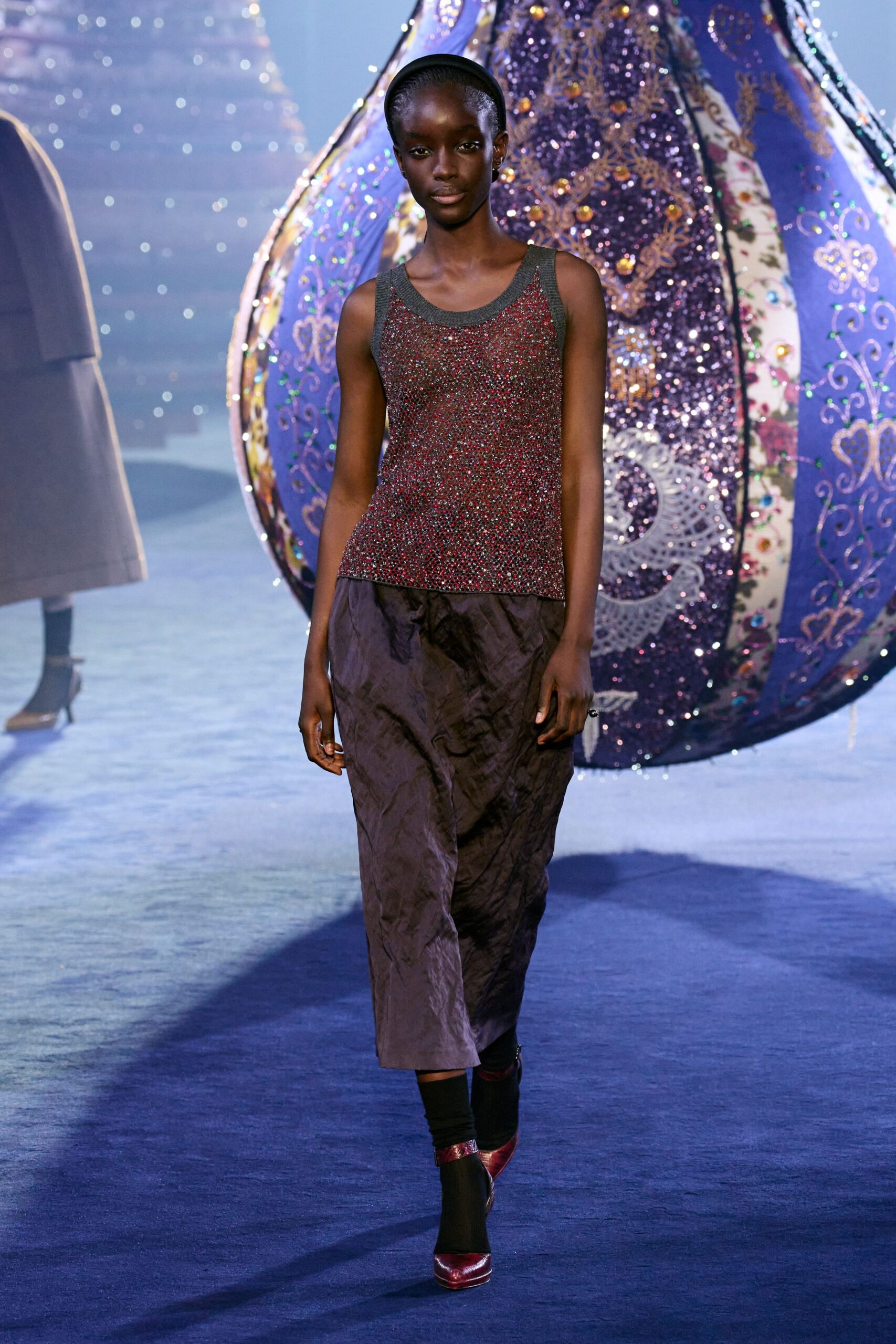 multi-colored sleeveless top with black midi skirt