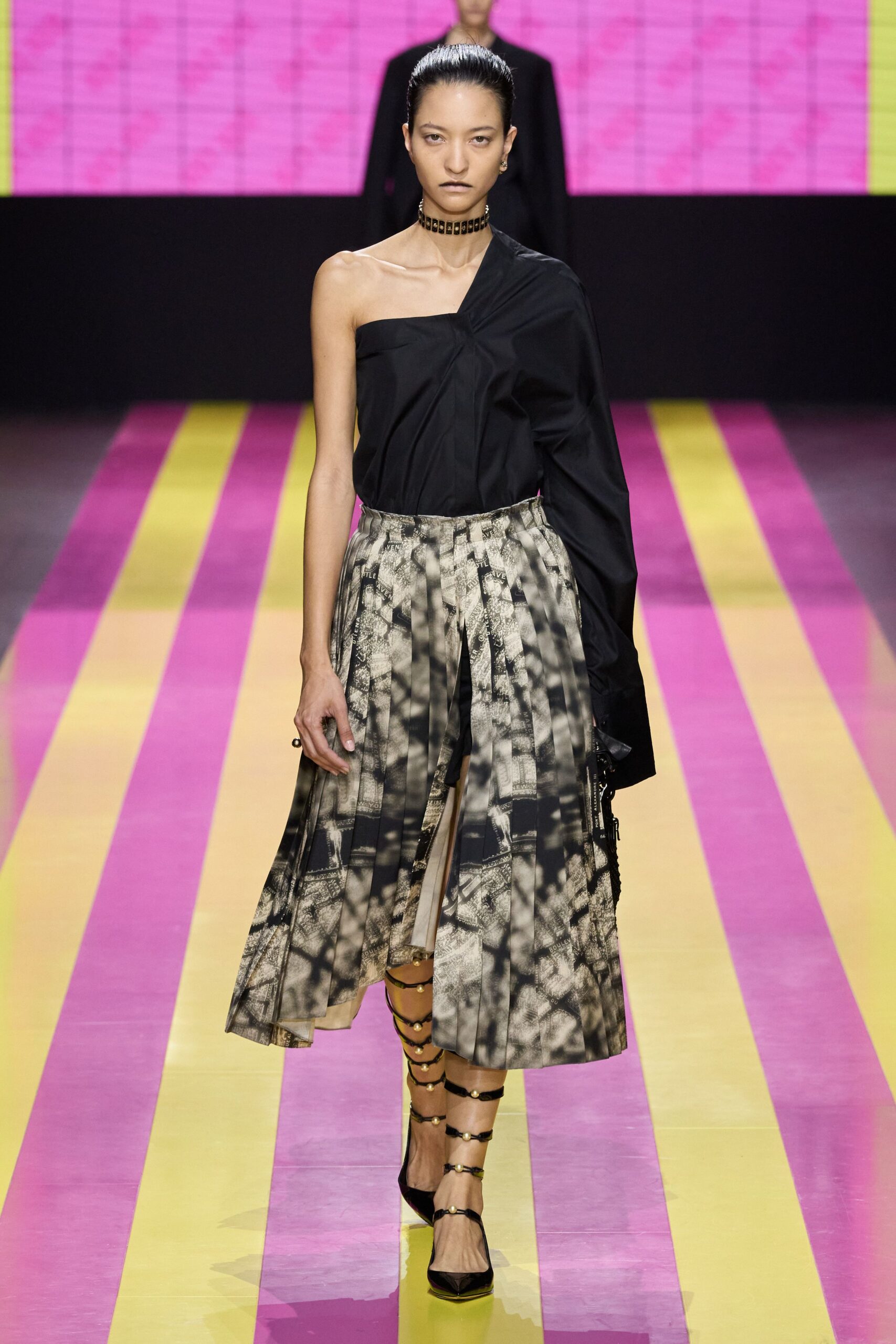 black asymmetric top with pleated skirt