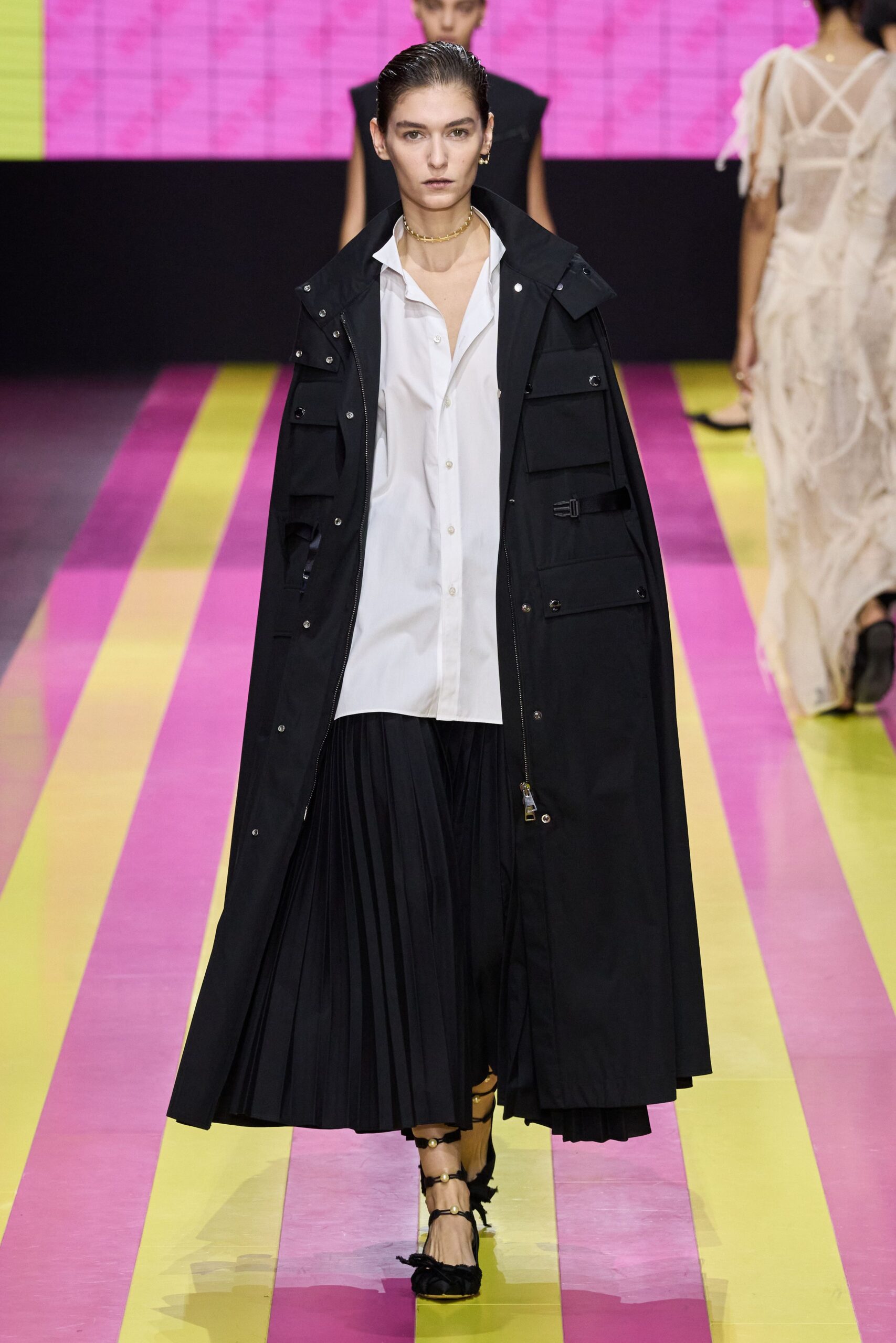 black coat white shirt pleated skirt