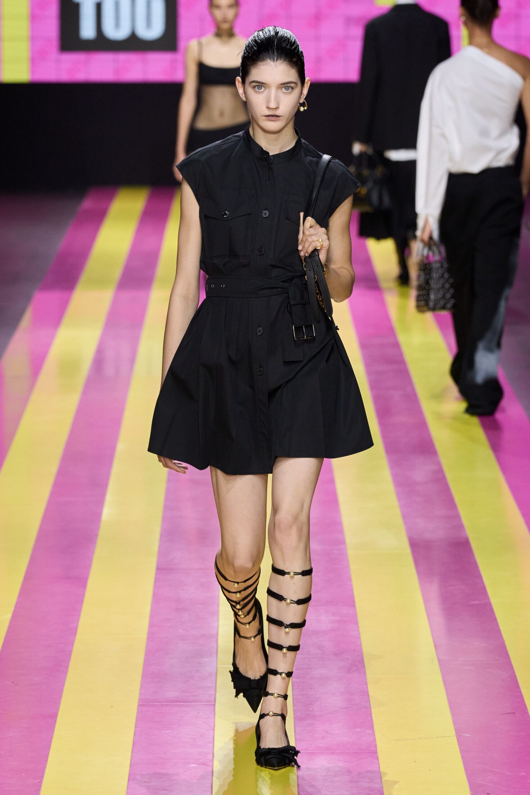 black fitted mini dress with strappy shoes