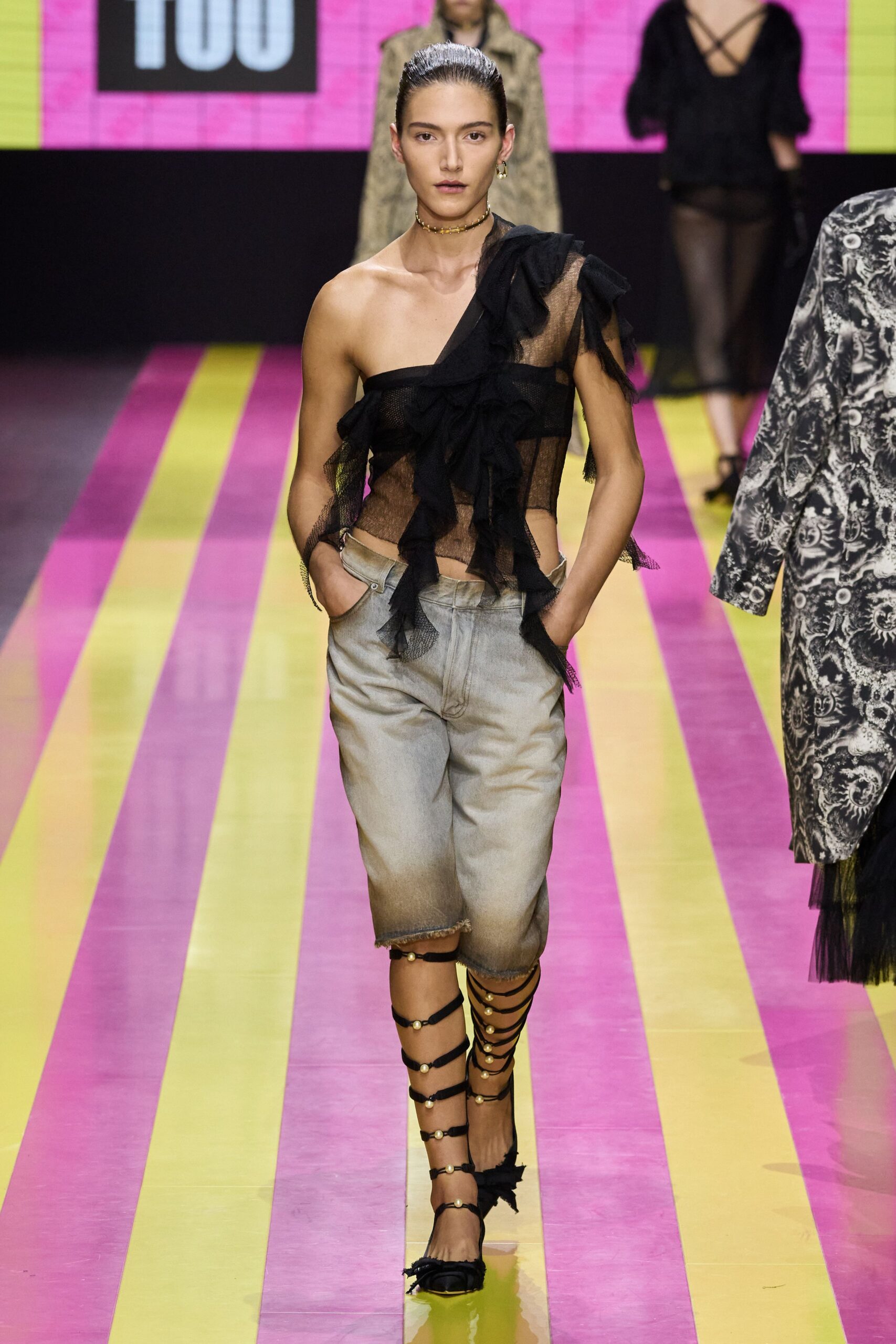 black mesh ruffled top with gray shorts