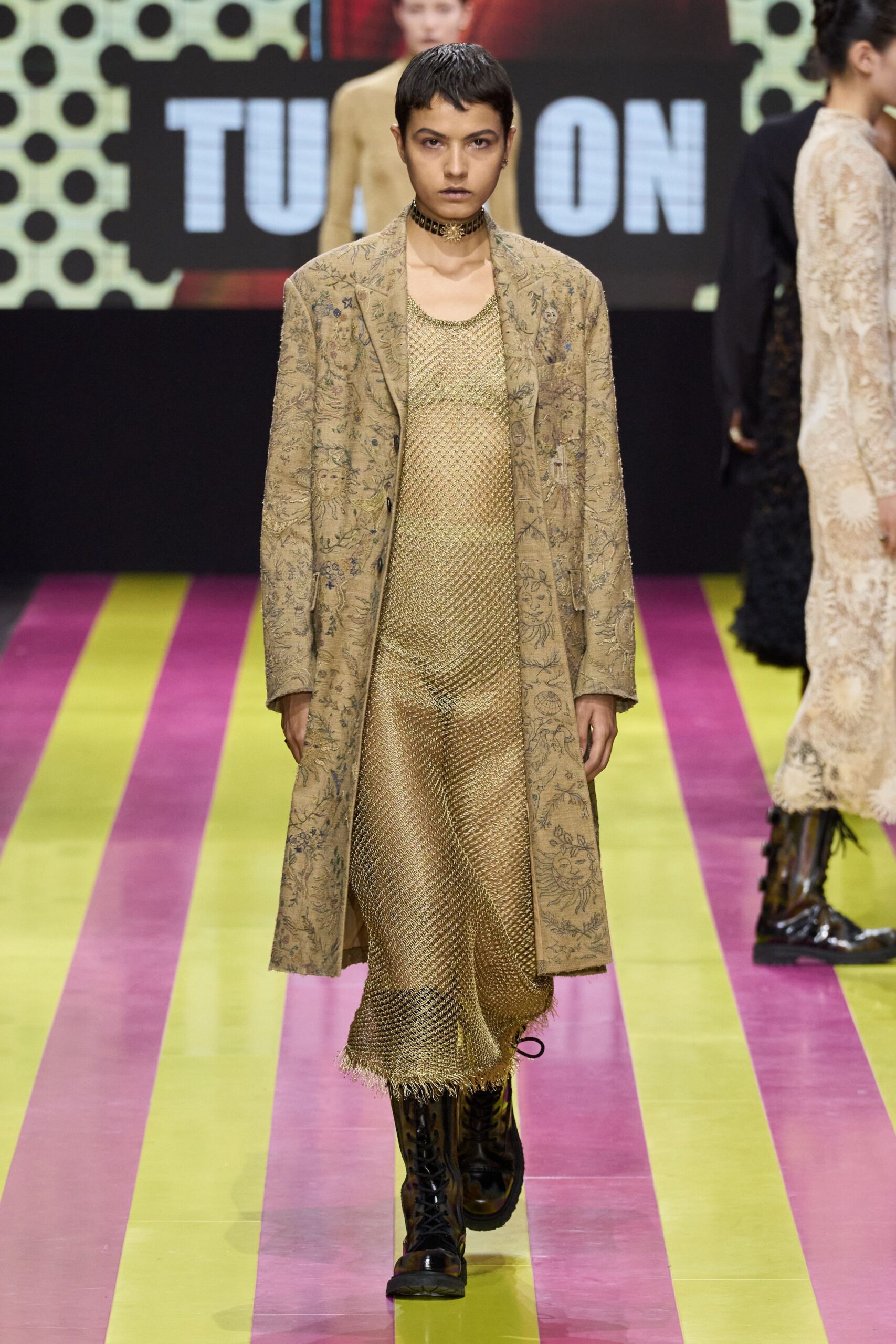 beige embroidered coat and gold mesh dress