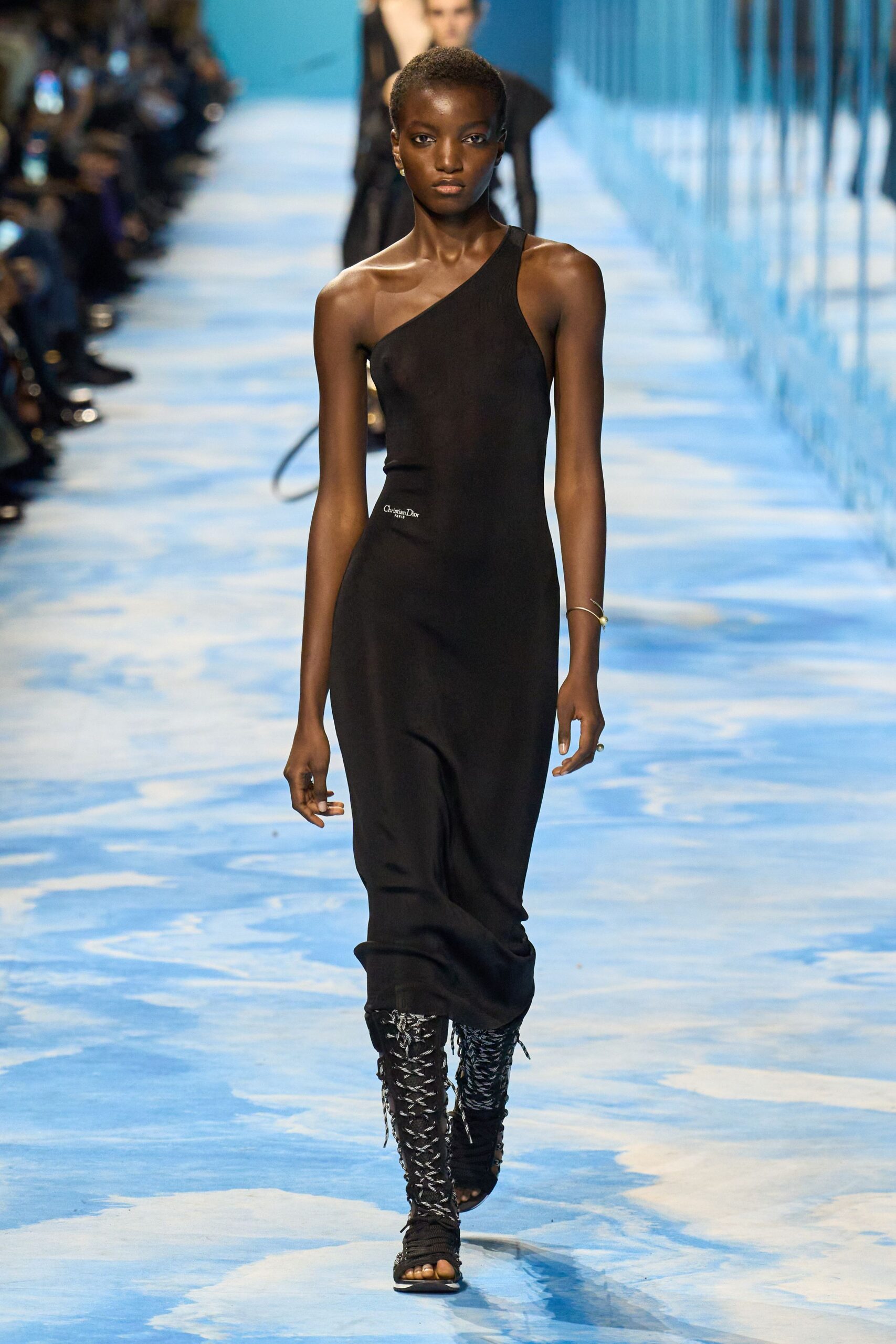 black fitted asymmetric dress with boots