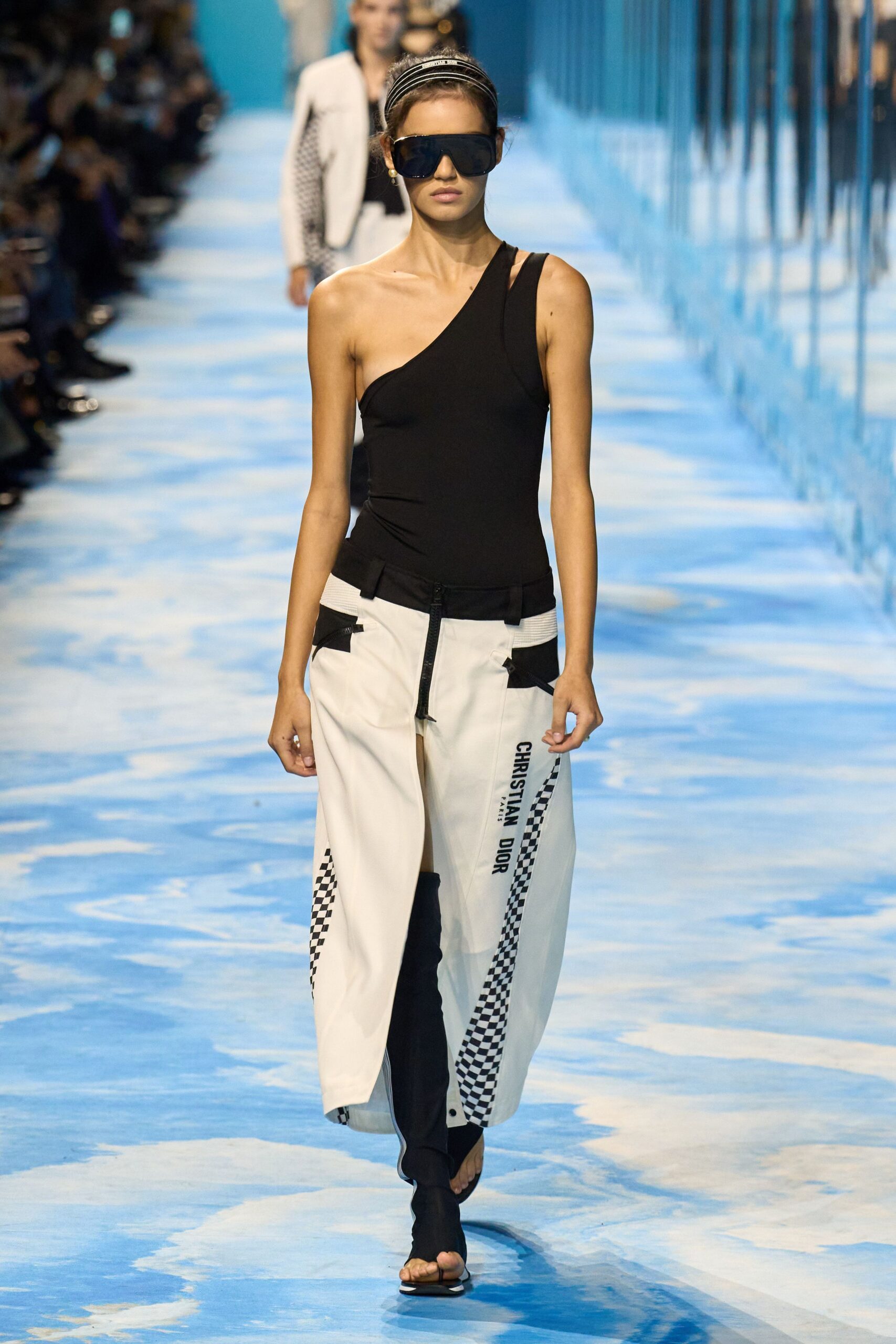 black asymmetric top with white pants