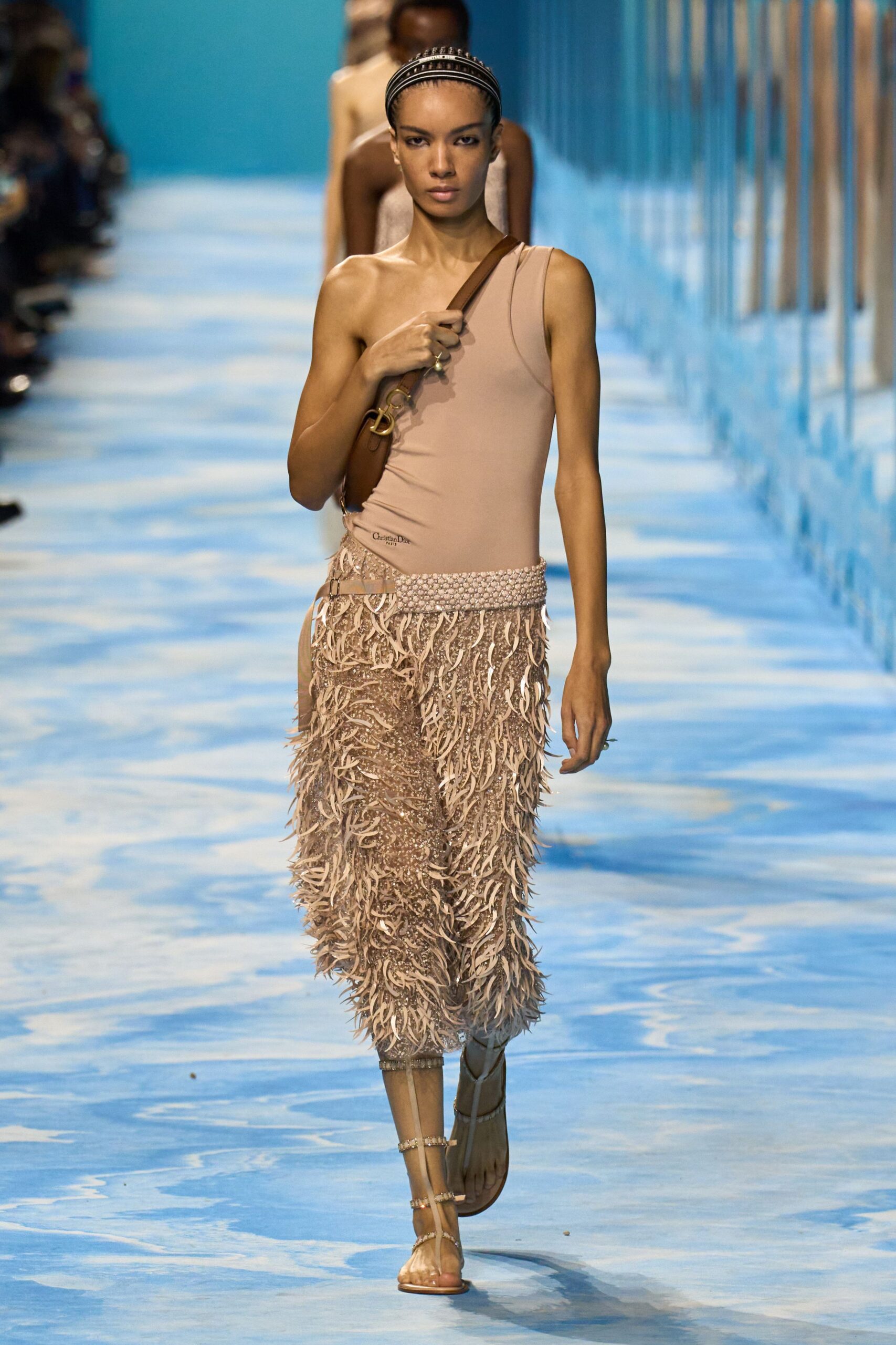 beige one-shoulder bodysuit with fringed skirt