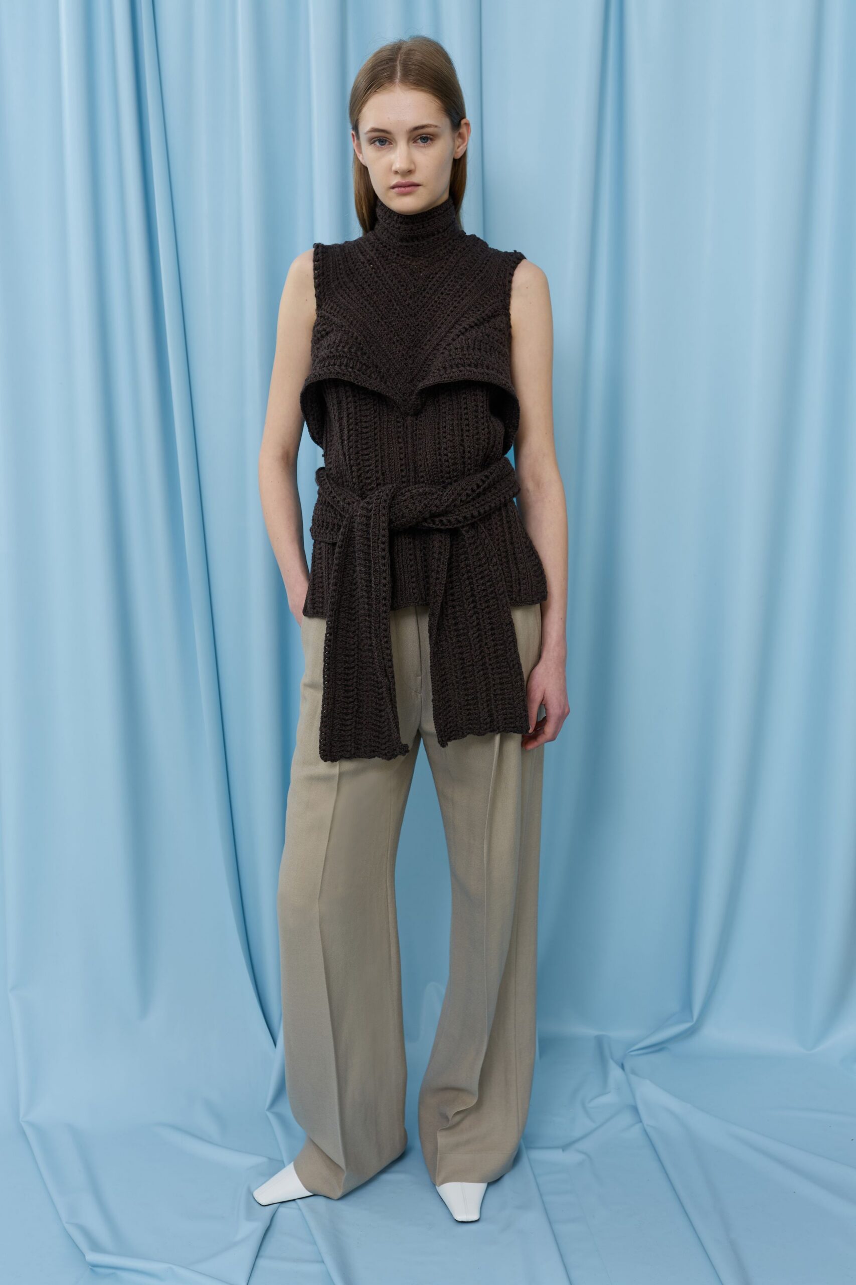 black knit sleeveless top with beige wide-leg pants