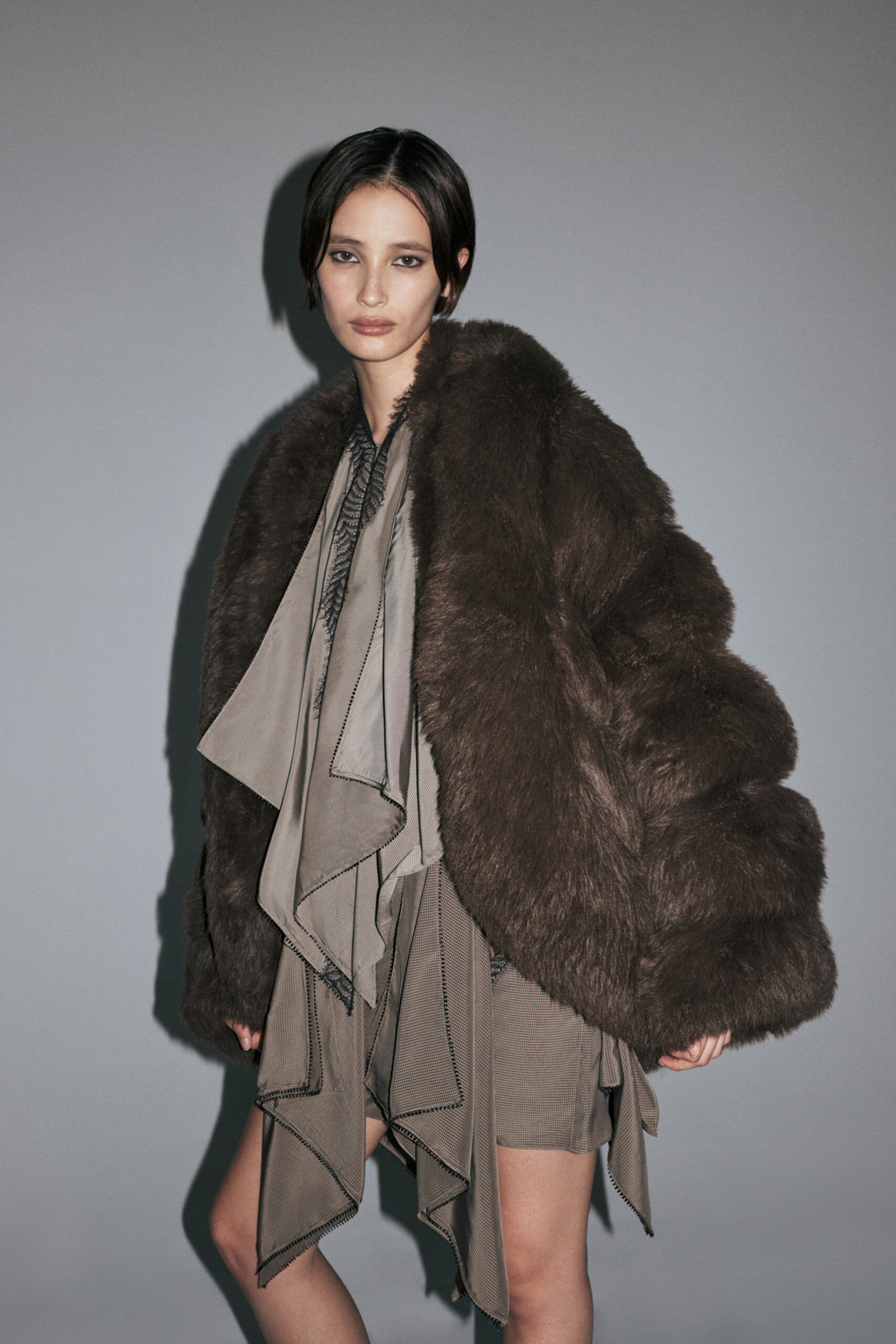brown faux-fur coat and gray dress
