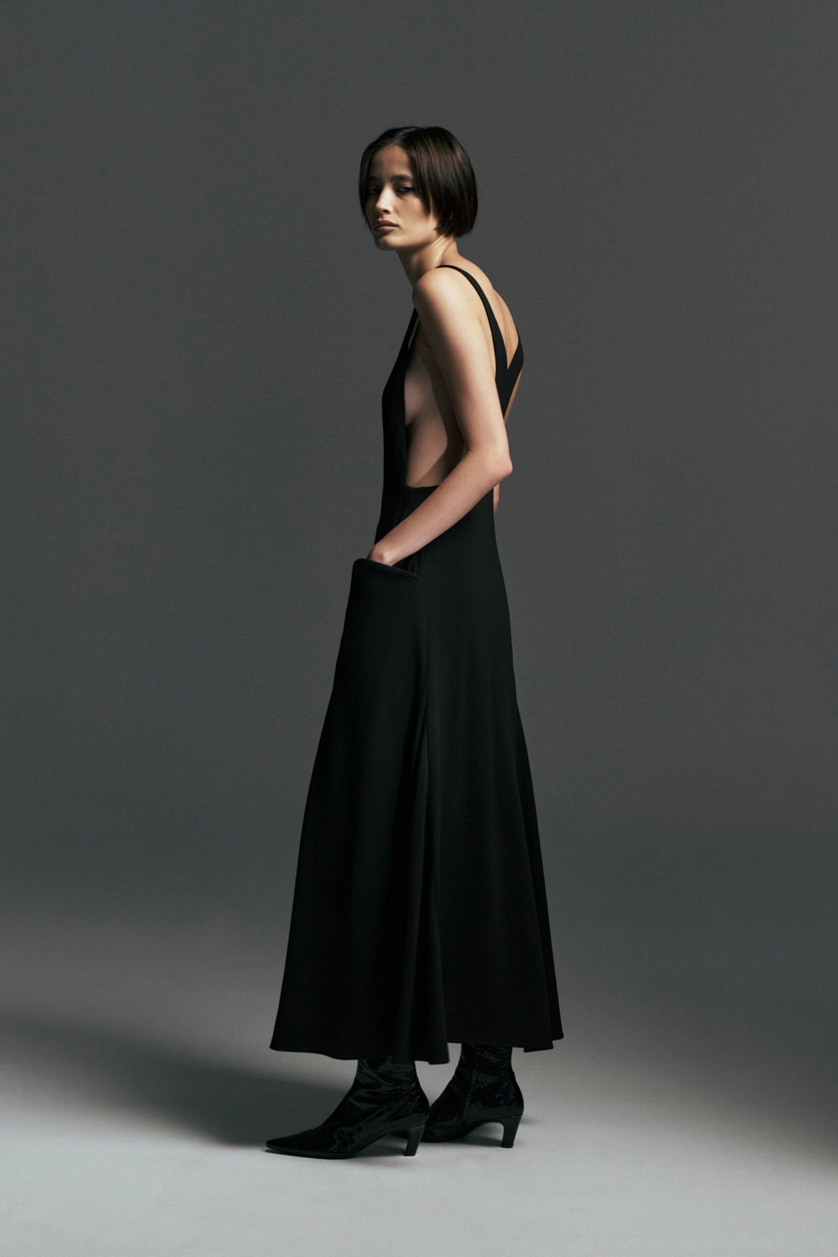 black silk backless maxi dress and boots