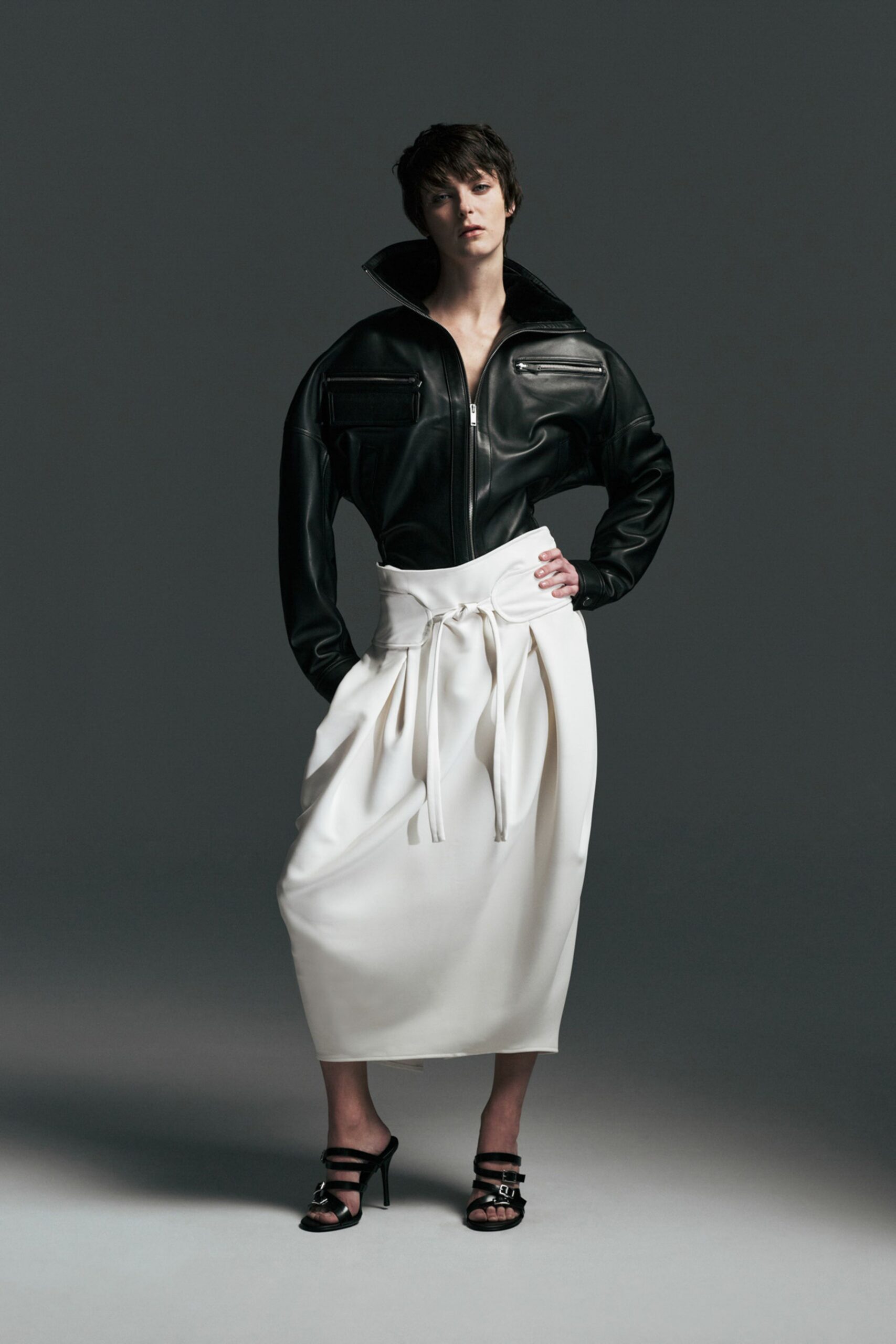 black leather jacket white pleated skirt