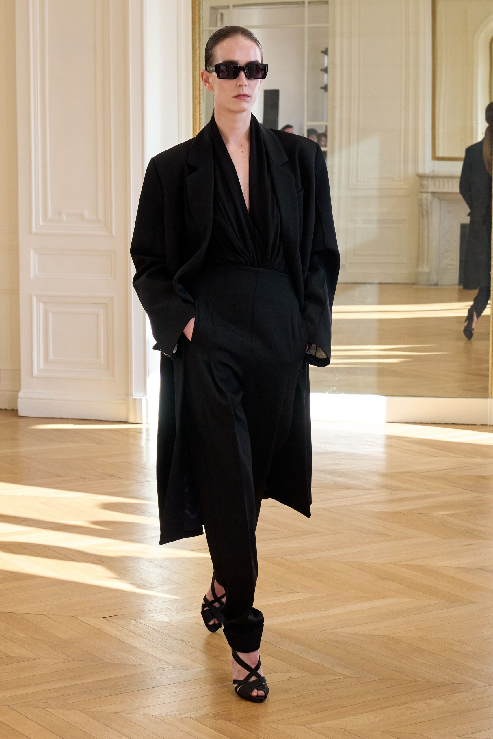 black oversized coat and fitted jumpsuit
