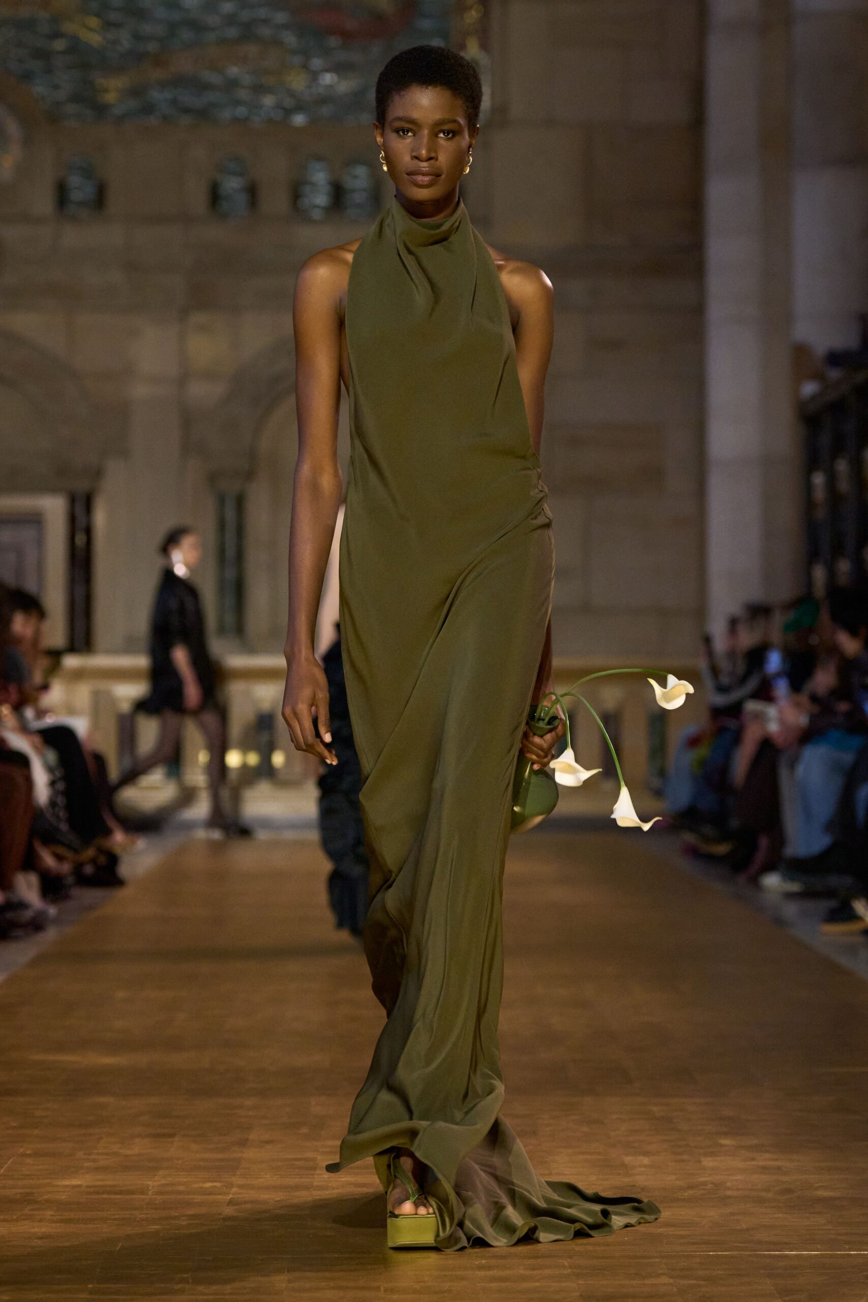 green silk sleeveless high-neck fitted draped flowing gown