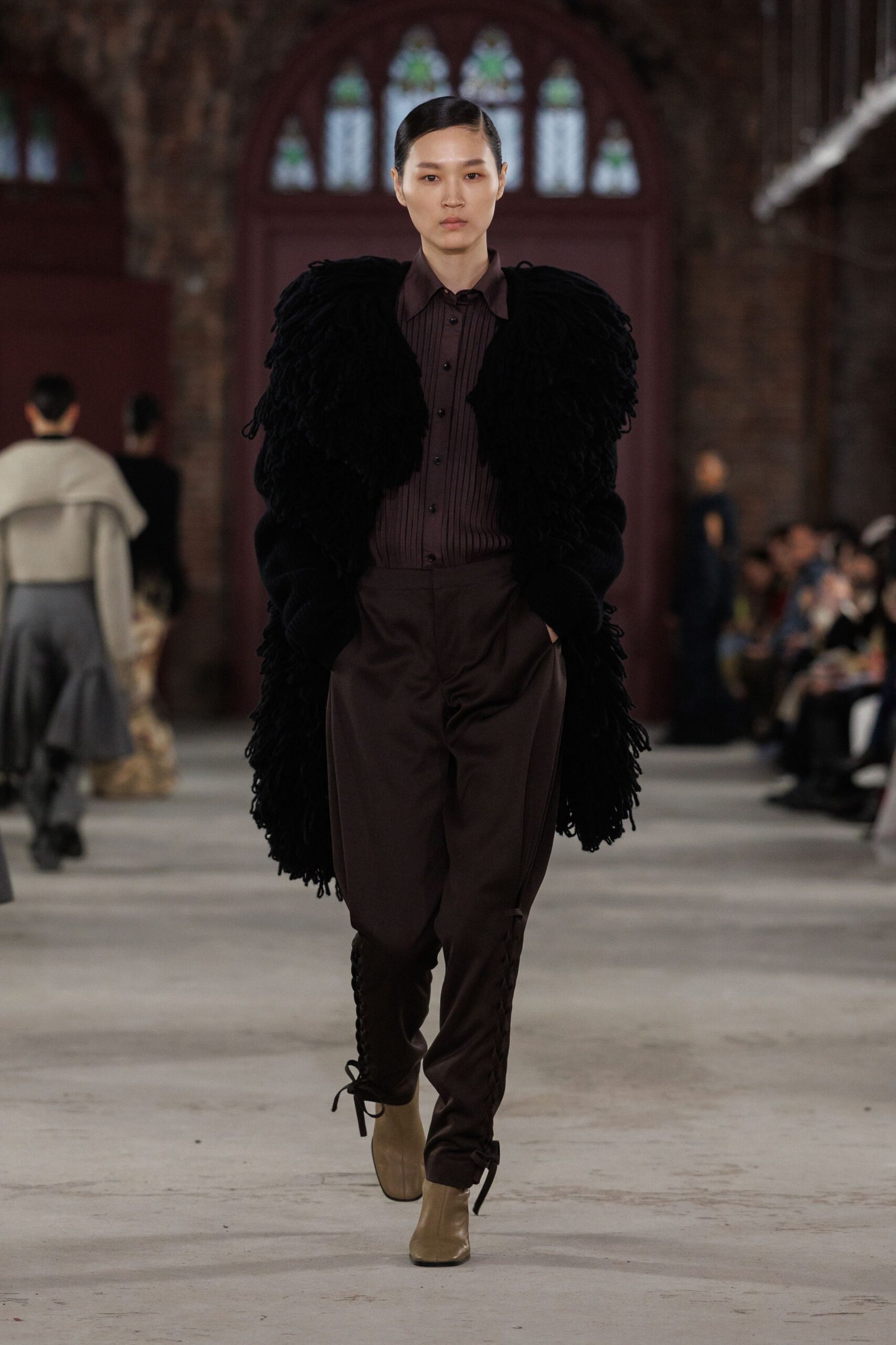 black fur coat brown shirt pants