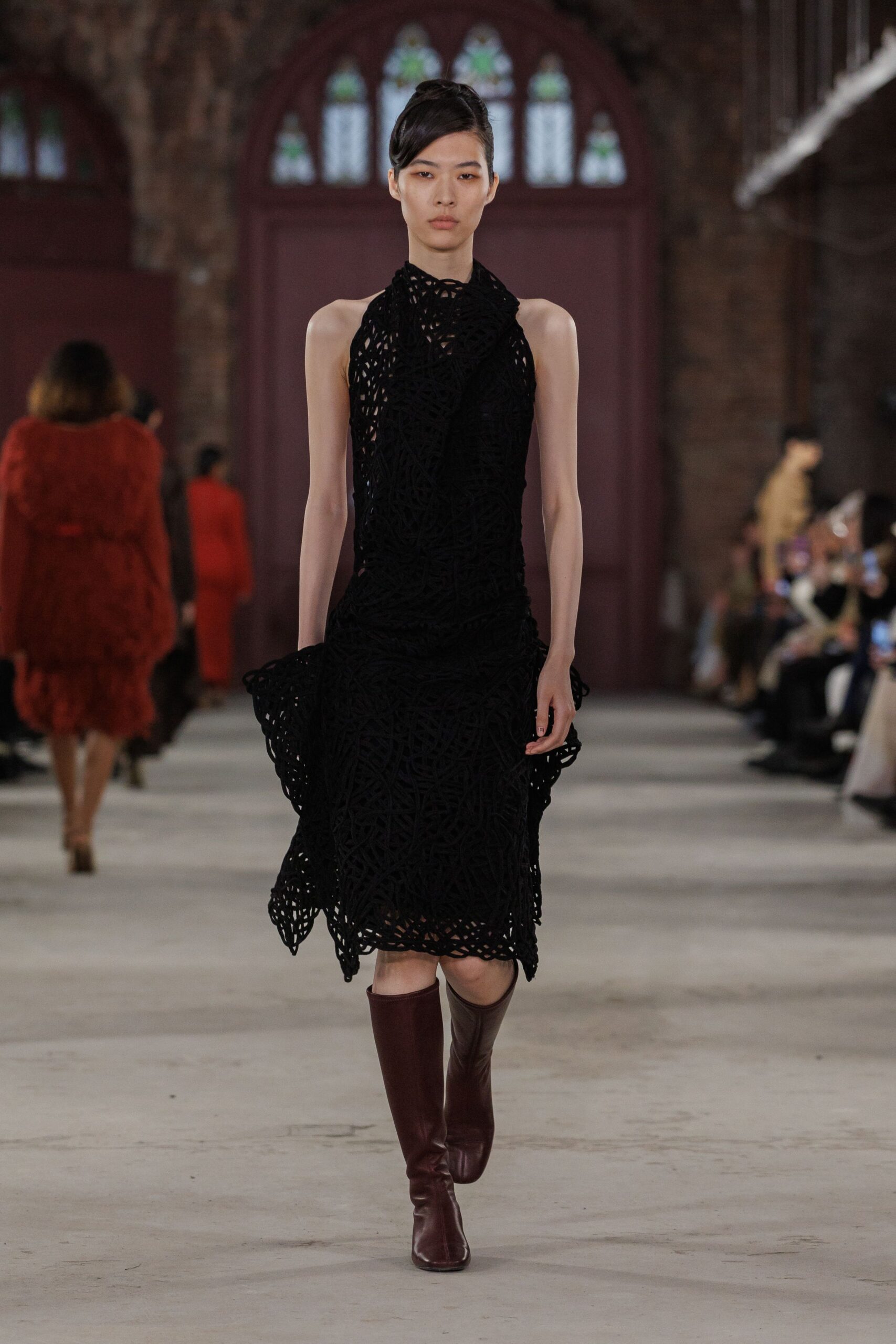 black fitted sleeveless dress with brown boots