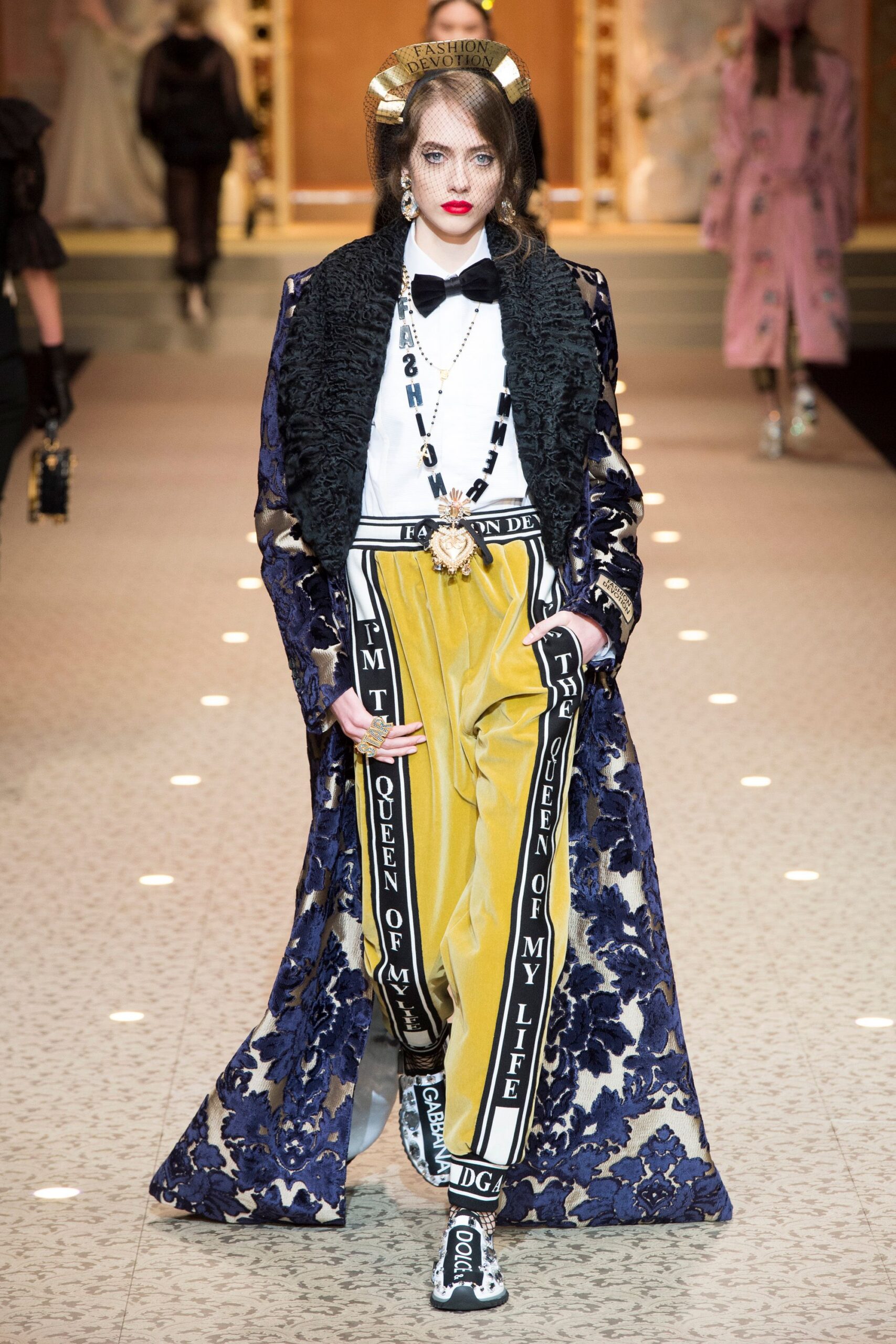 blue embroidered coat with yellow pants