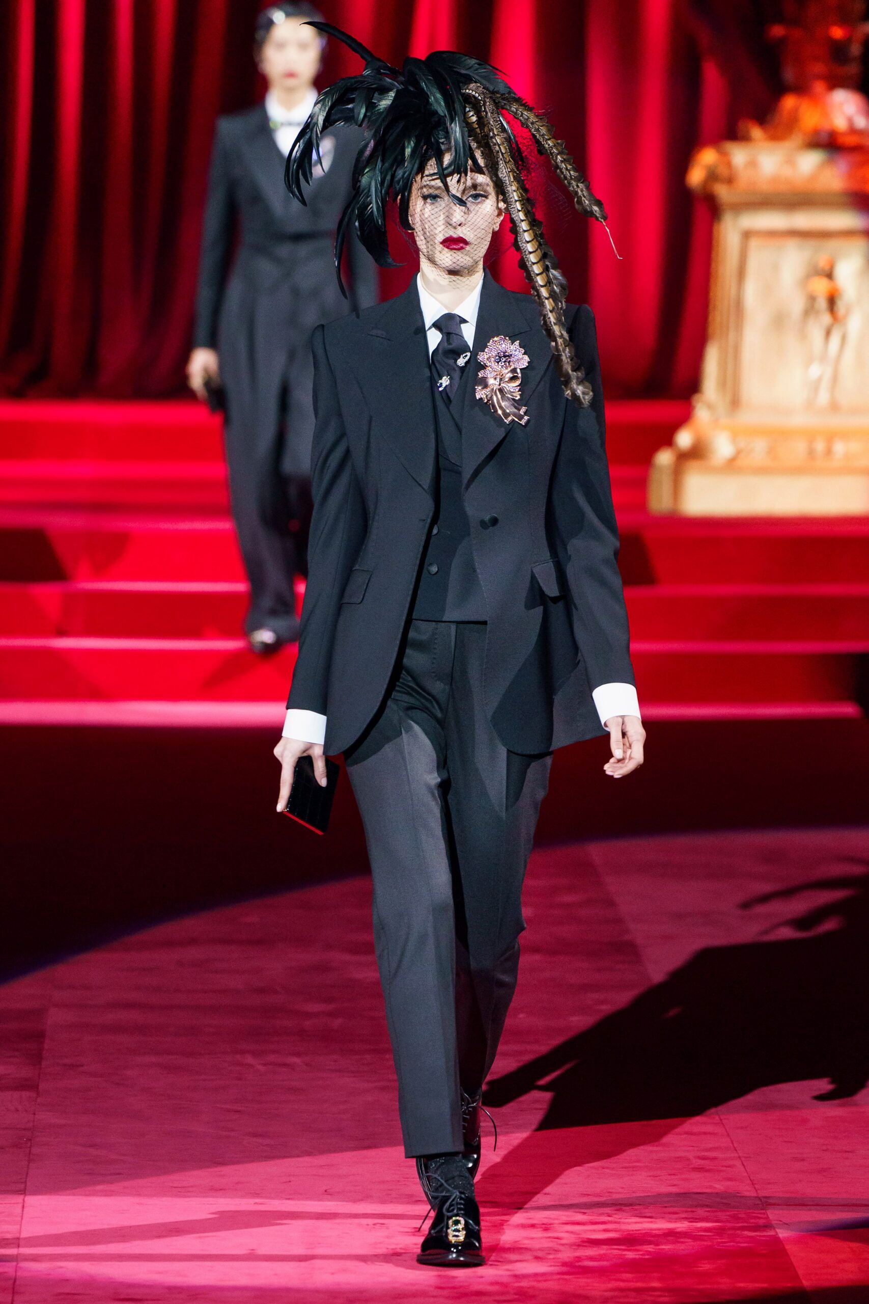black tailored suit with feathered hat