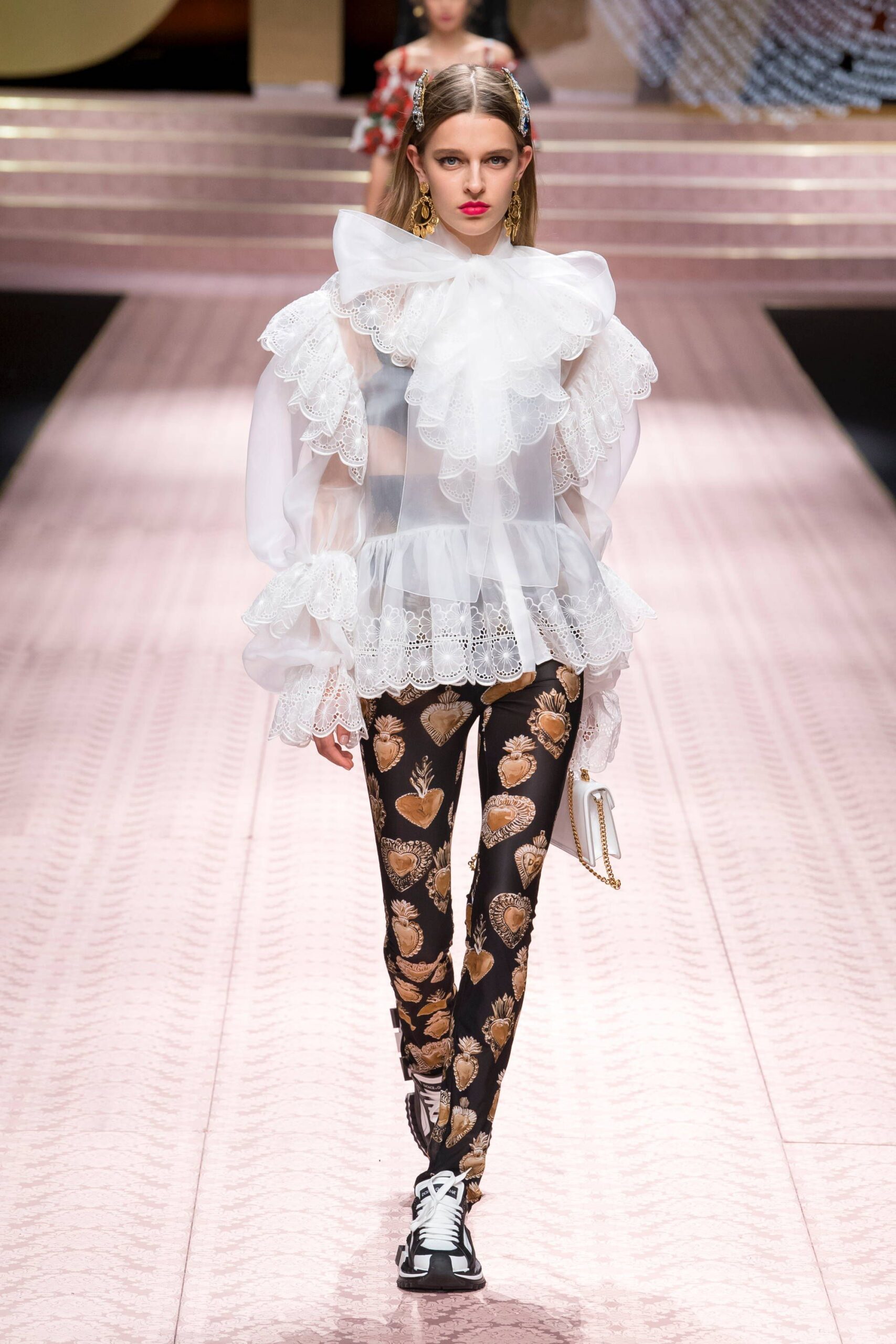 white ruffled blouse with printed pants